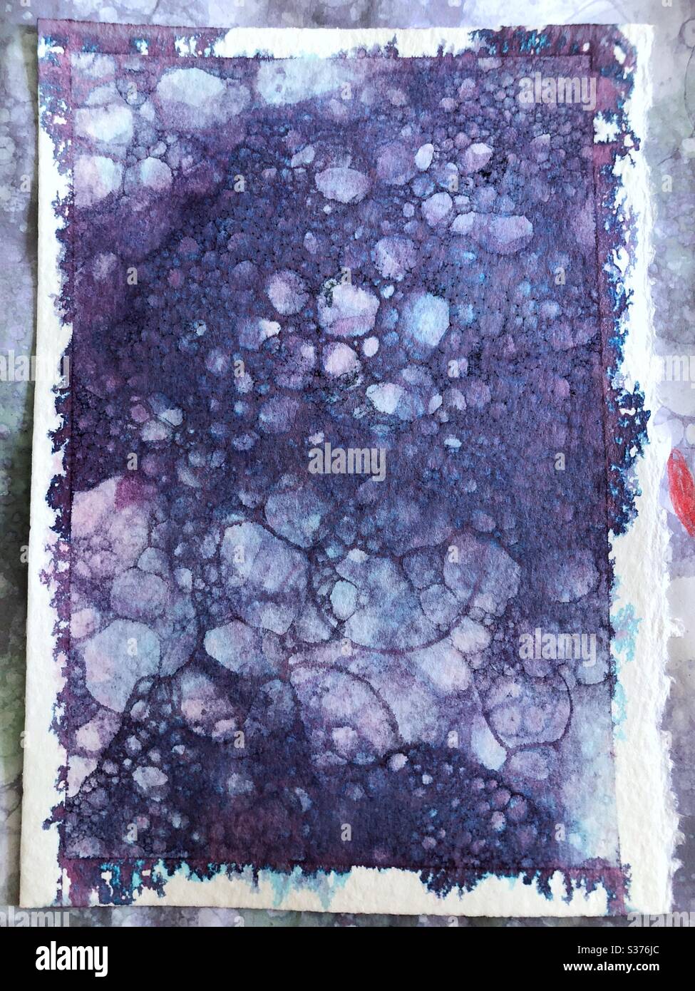 Soap bubble and purple food coloring bubble print abstract background on watercolor paper - Smartphone Captured Stock Image