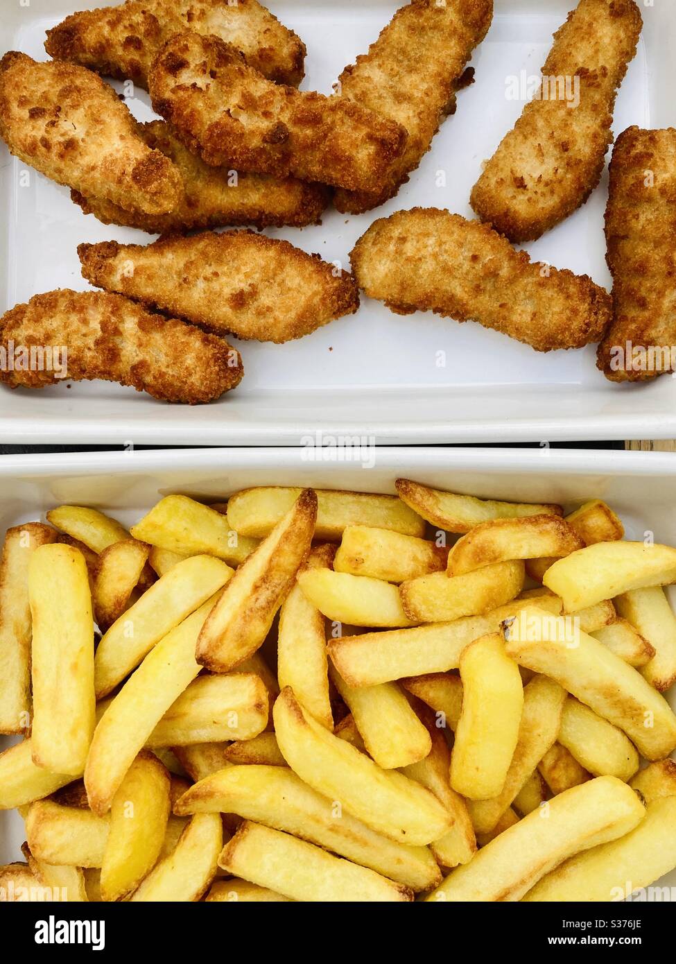 Battered Chicken strips with chunky chips Stock Photo Alamy