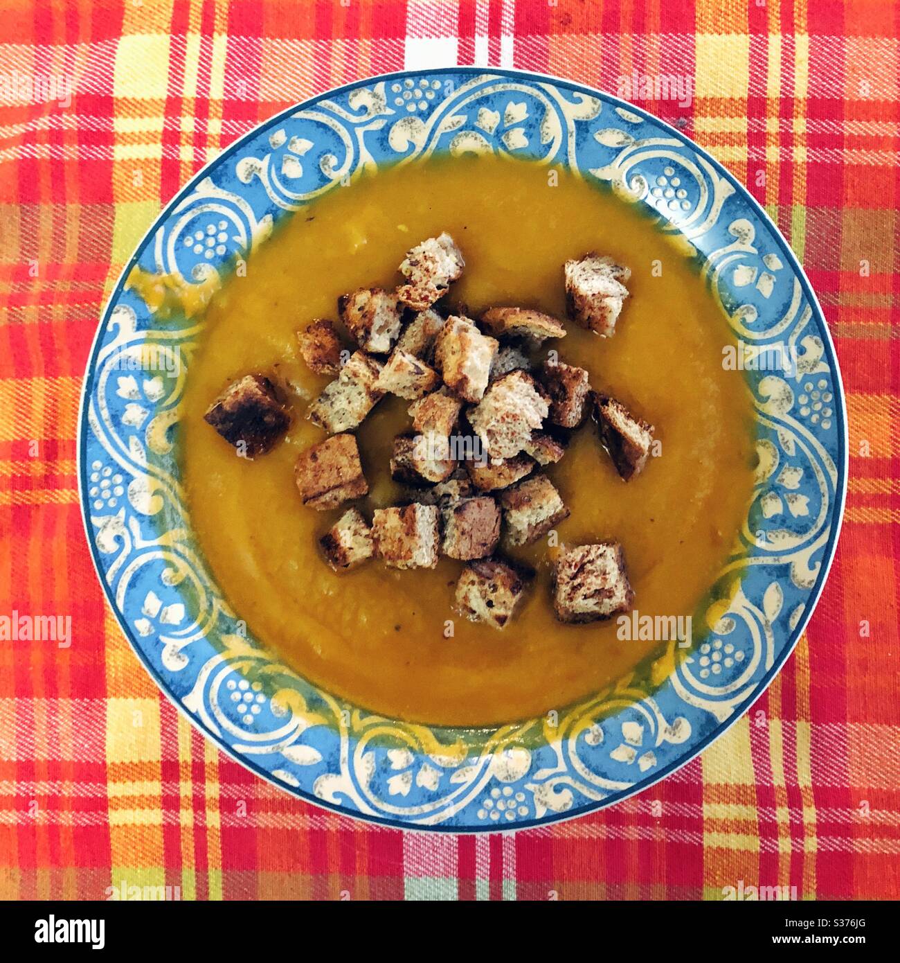 Whole wheat croutons in pea soup bowl - Smartphone Captured Stock Image