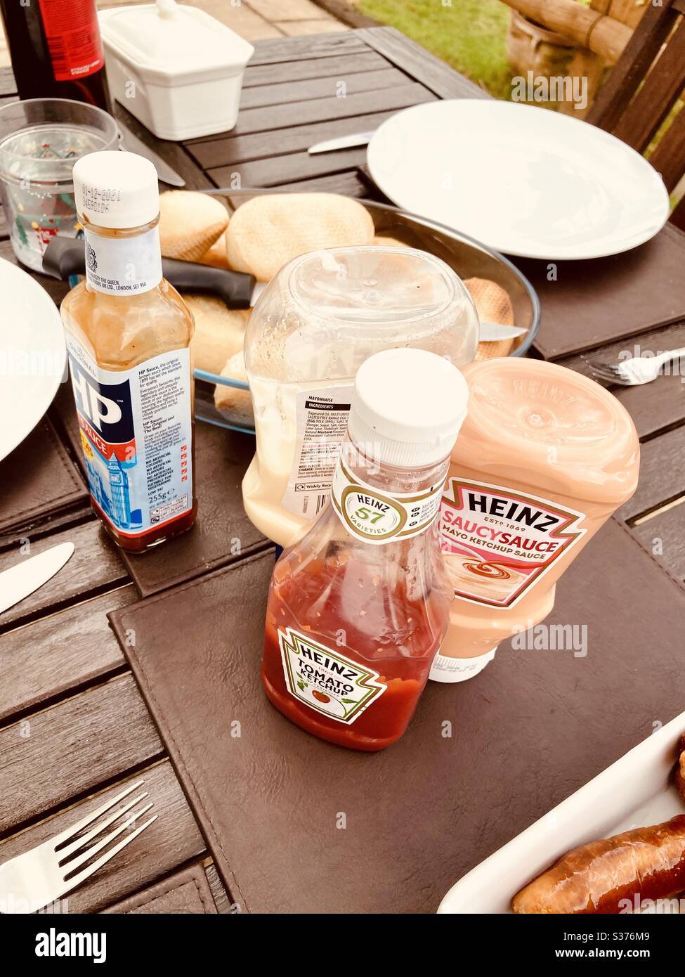 https://c8.alamy.com/comp/S376M9/various-sauces-on-a-outside-wooden-table-for-a-barbecue-S376M9.jpg