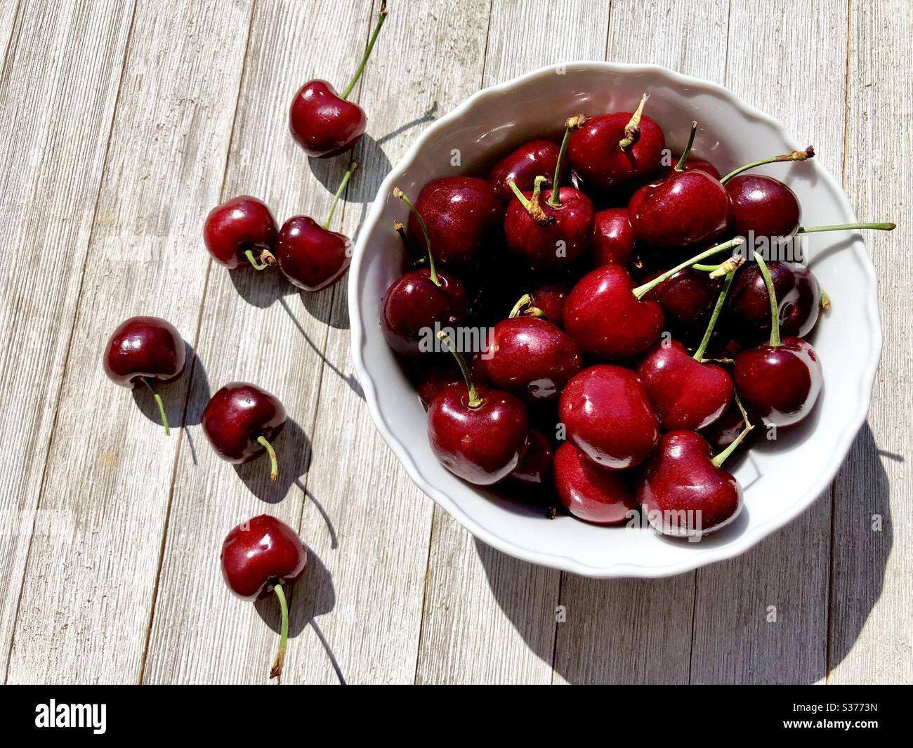 Sweet cherries in a white bowl Stock Photo