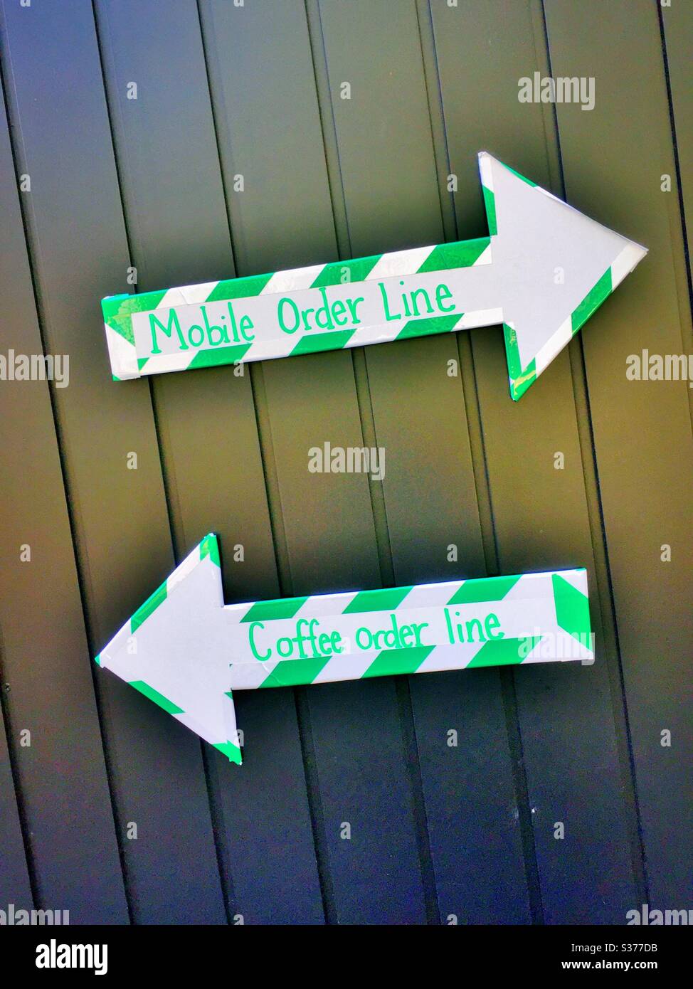 Arrows directing customers at a coffee shop during the COVID-19 pandemic, 2020, USA - Smartphone Captured Stock Image