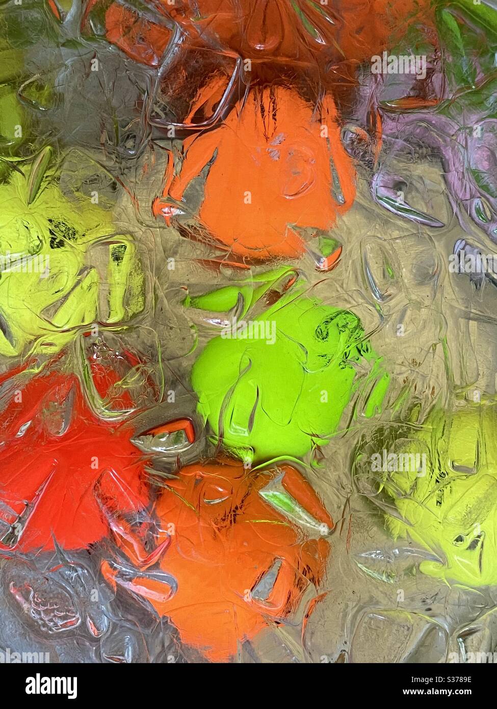 Abstract background of colorful golf balls submerged in ice water - Smartphone Captured Stock Image