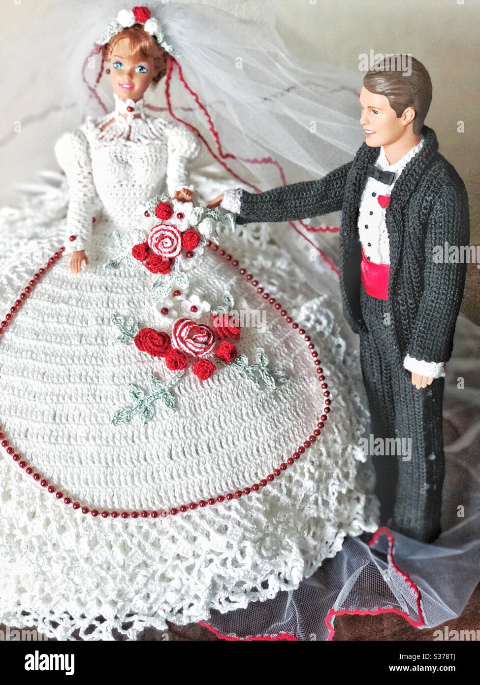 Ken and Barbie in elaborate crocheted wedding outfits Stock Photo