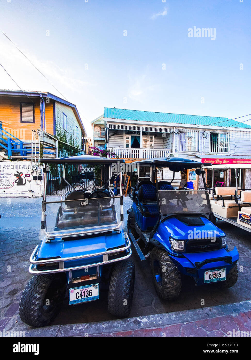 Golf carts parked in downtown San Pedro, Ambergris Caye, Belize on March 10, 2020. - Smartphone Captured Stock Image