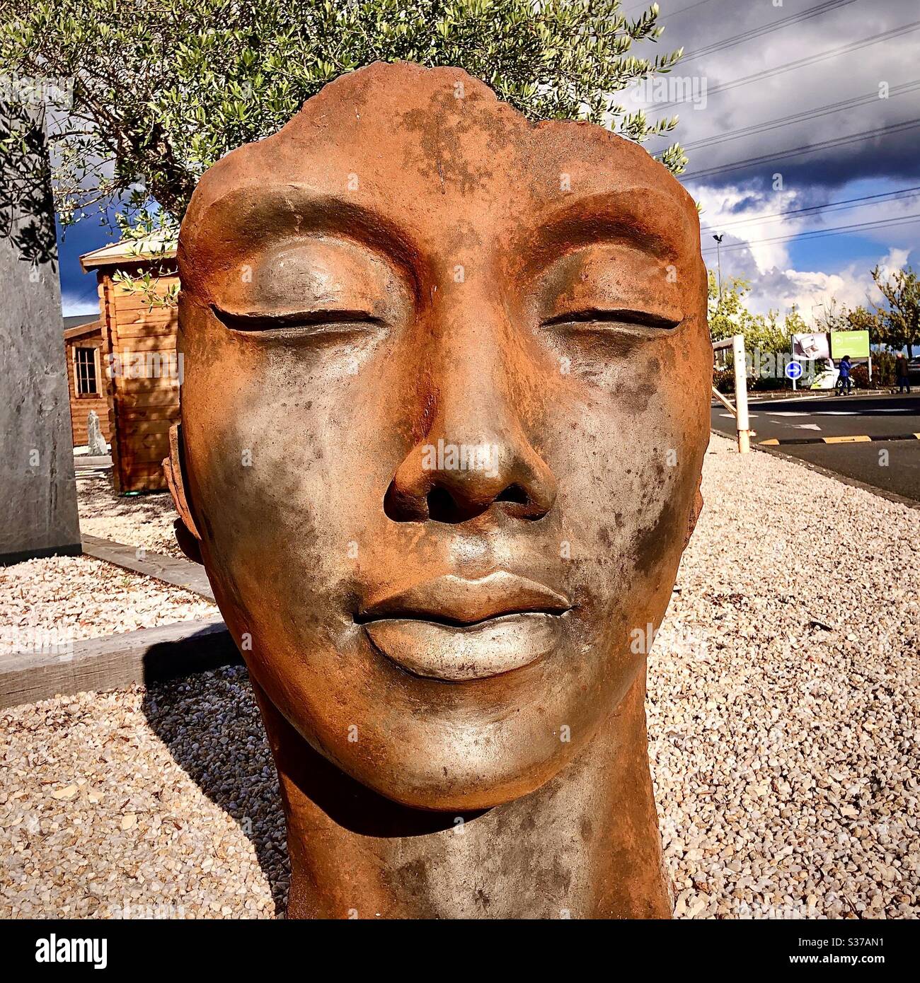 Cast iron Oriental head decoration for gardens. - Smartphone Captured Stock Image