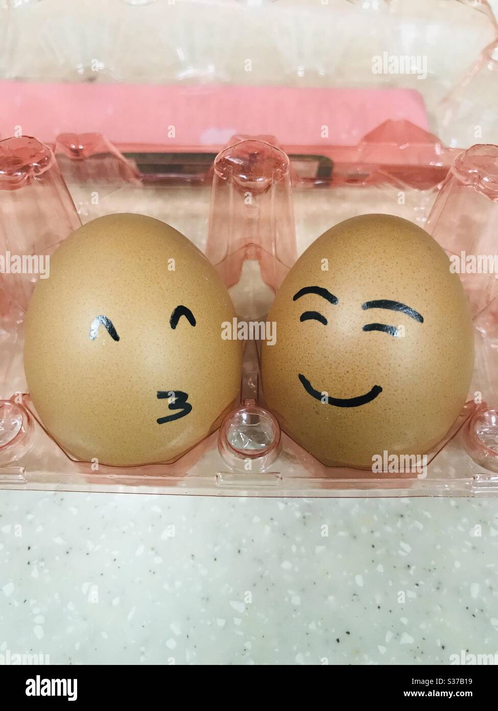 Mixed feeling Eggs in egg holder , Easter eggs, Happy Eggs Stock Photo