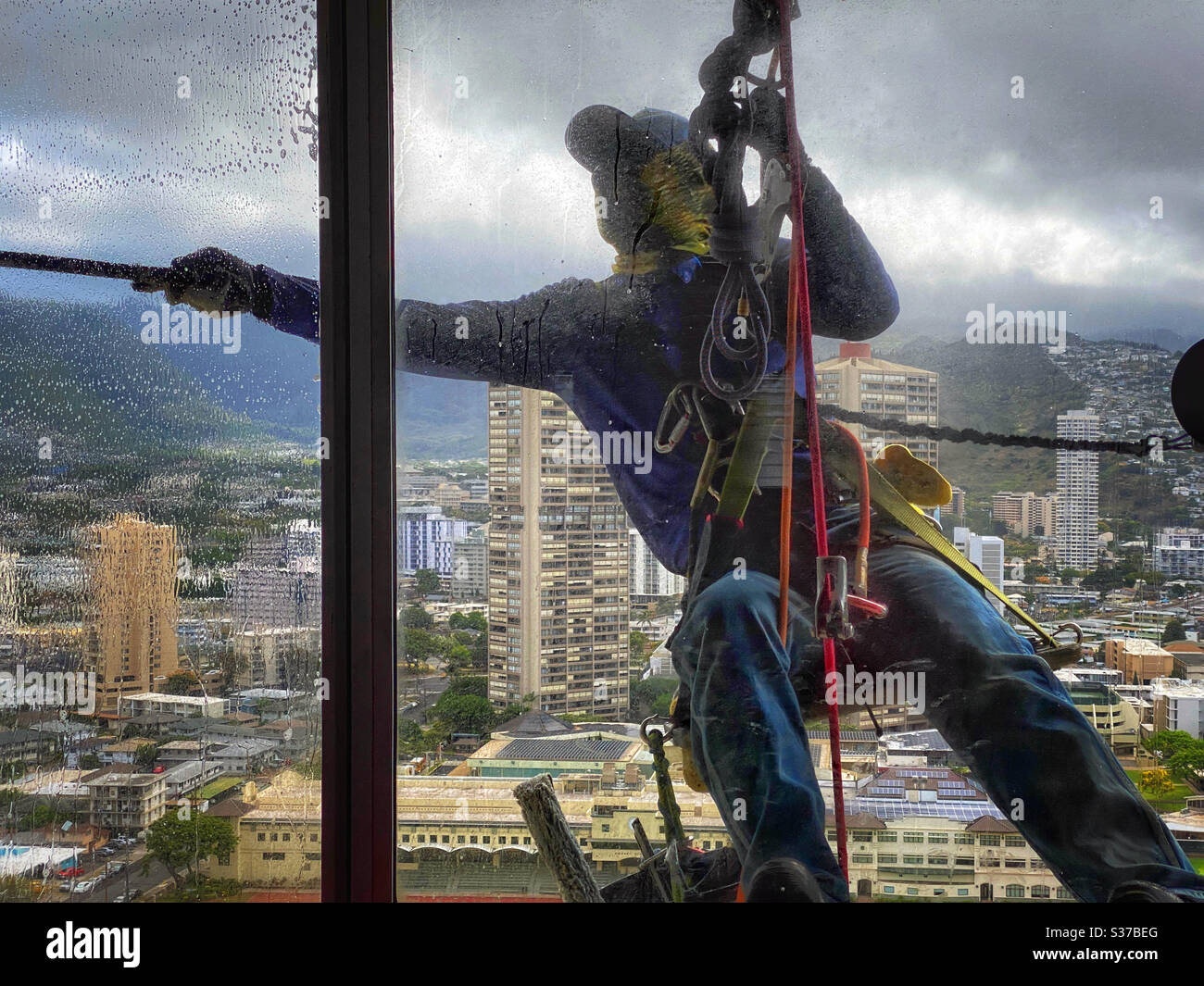 Window washer working on high-rise building windows Stock Photo