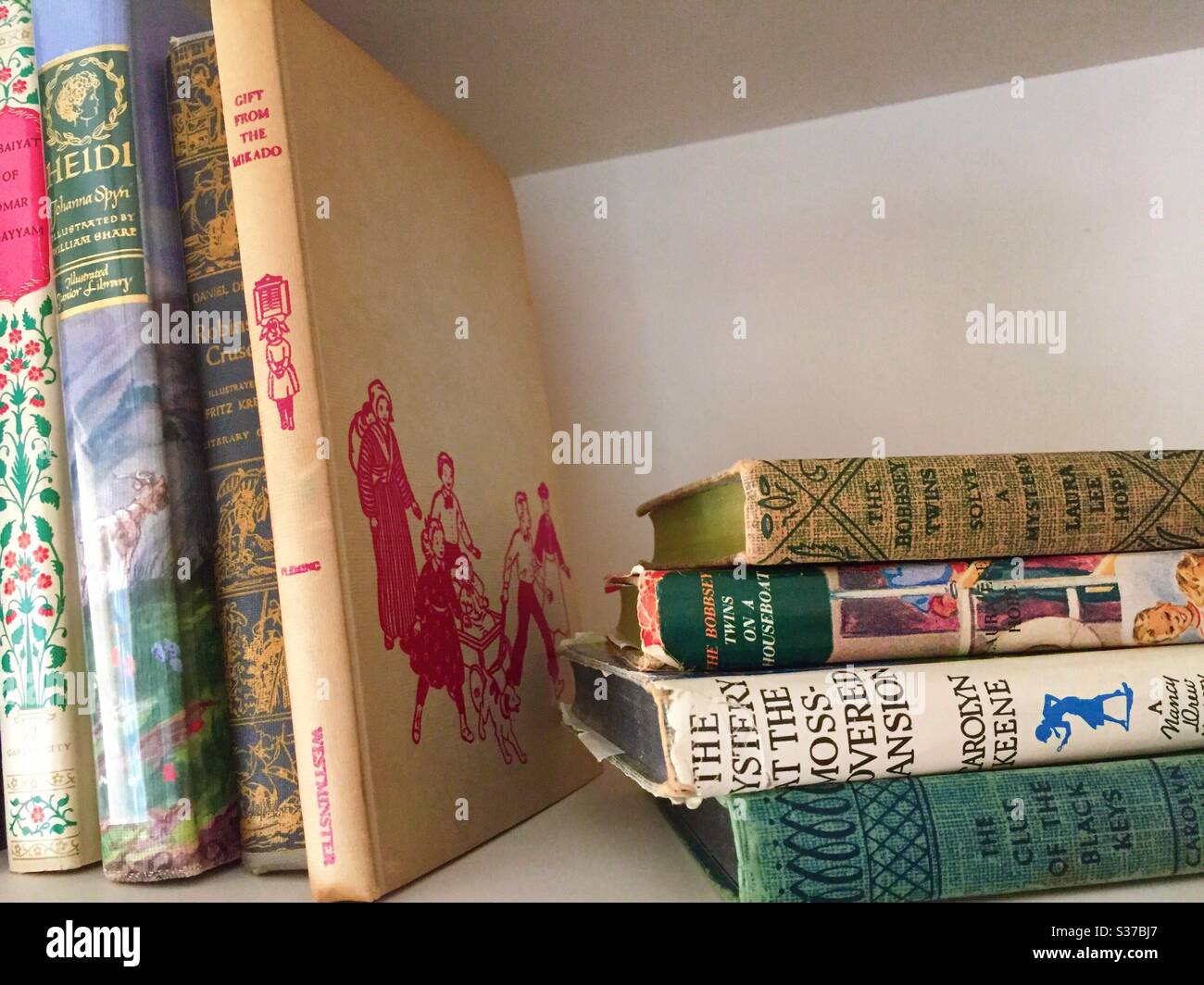 A residential bookshelf filled with vintage books, USA - Smartphone Captured Stock Image