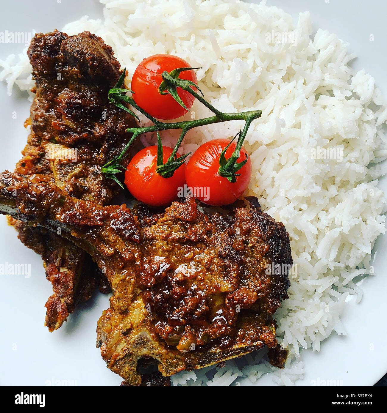 Home made lamb chops with slow cooked cherry tomatoes Stock Photo Alamy