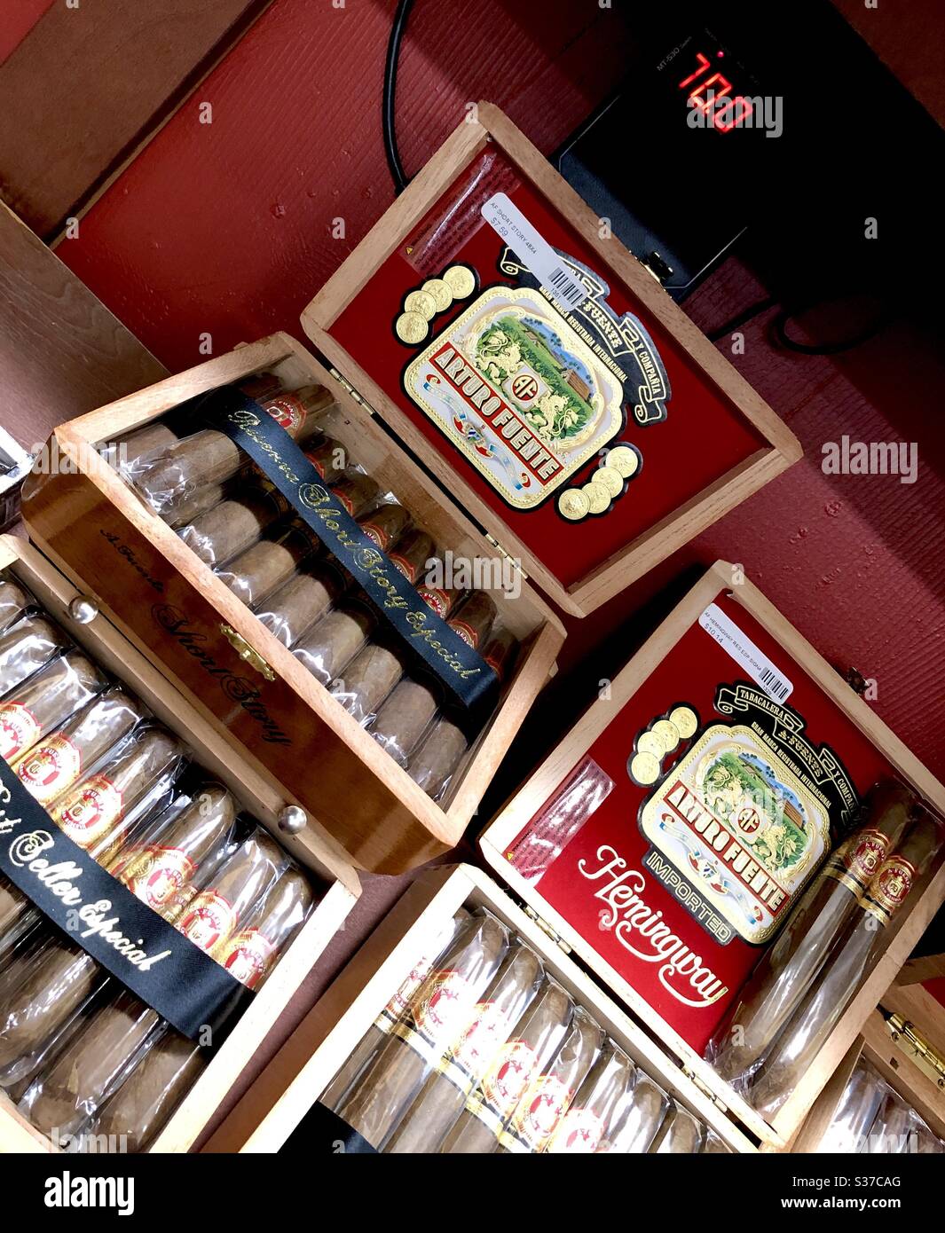 The interior of a cigar shop humidor shows the thermostat temperature at 70°, with a humidity level to keep the cigars at the correct moisture. - Smartphone Captured Stock Image