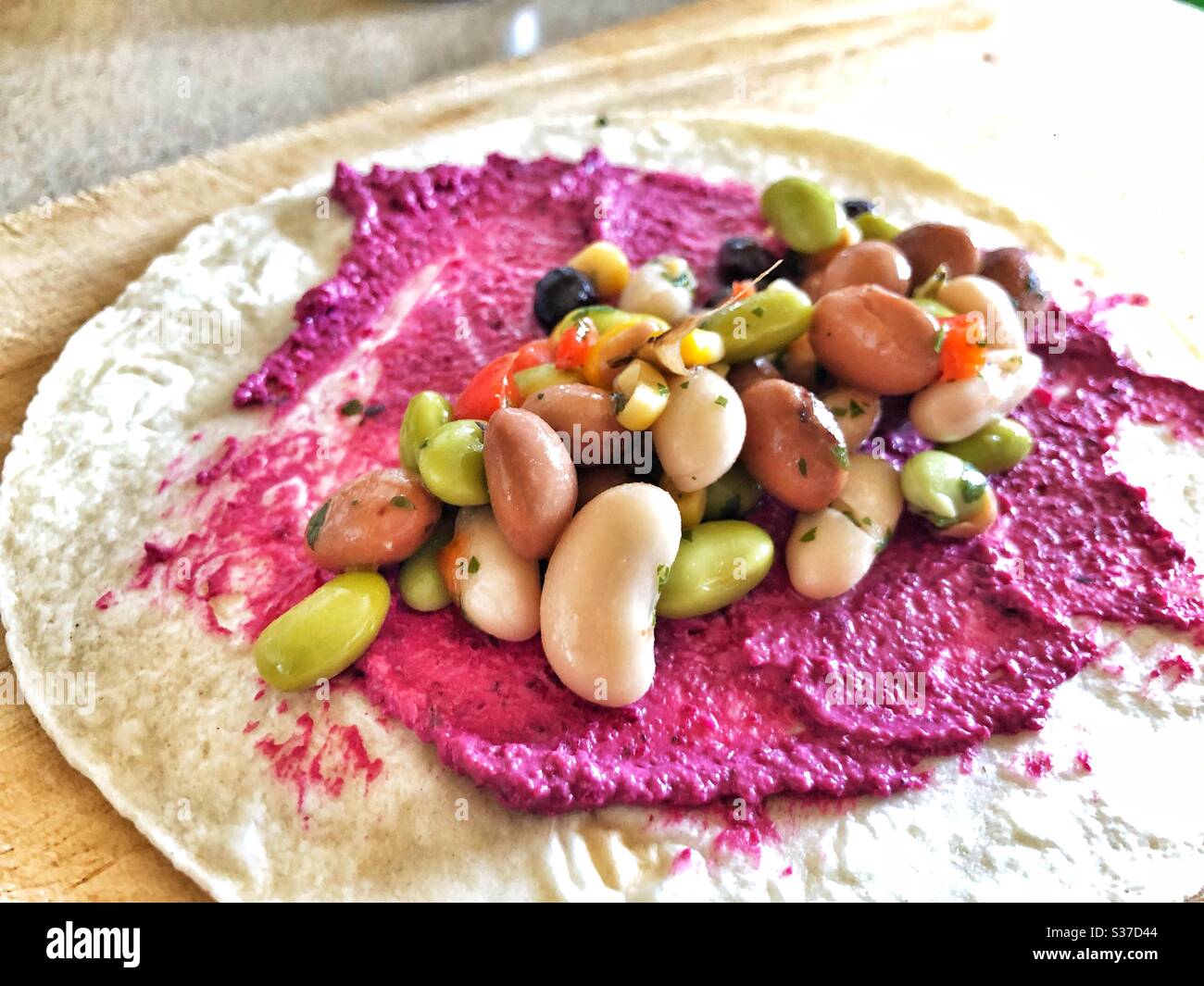 Five bean salad with beetroot houmous on a tortilla - Smartphone Captured Stock Image