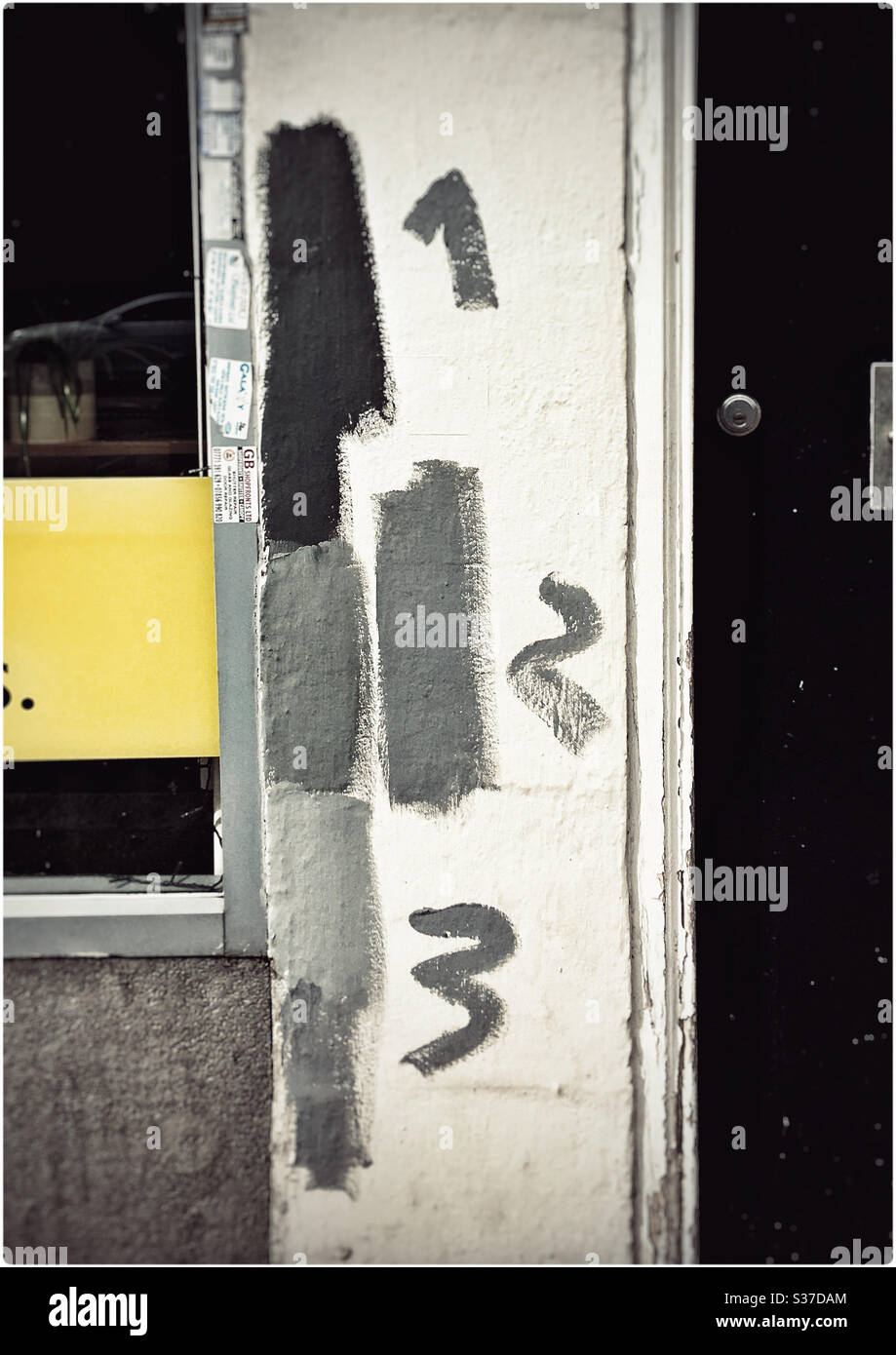 Shades of grey - testing paints 1,2 and 3 on a doorframe - Smartphone Captured Stock Image