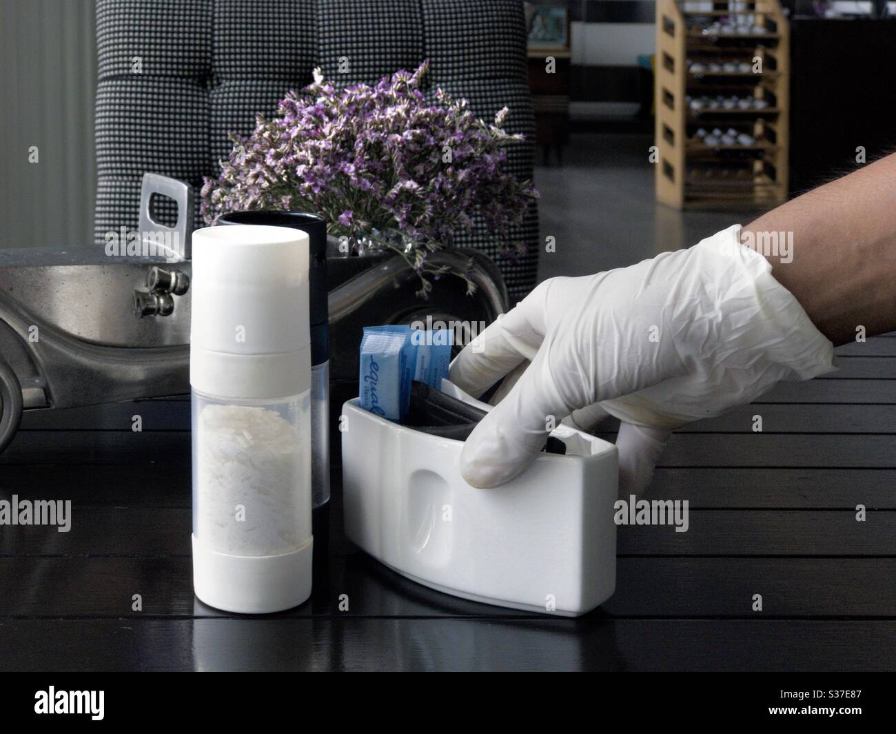 COVID-19 awareness by restaurant staff wearing latex gloves whilst serving customer - Smartphone Captured Stock Image