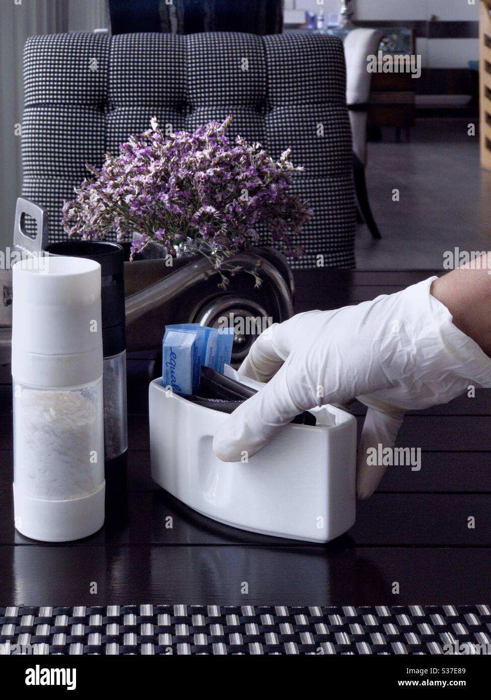 COVID-19 awareness by restaurant staff wearing latex gloves whilst serving customer - Smartphone Captured Stock Image