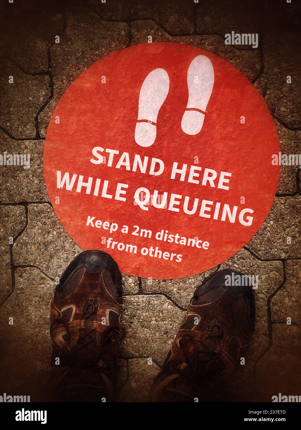 “STAND HERE WHILE QUEUEING” Keep a 2m distance from others. Safety & security in the times of Covid-19. Photo Credit - ©️ COLIN HOSKINS. - Smartphone Captured Stock Image