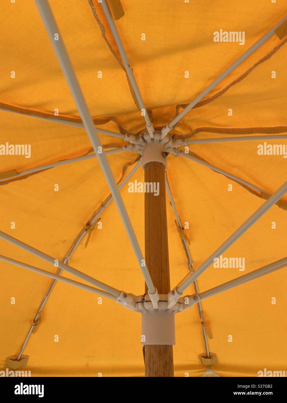 Underside of a bright yellow outdoor umbrella Stock Photo Alamy