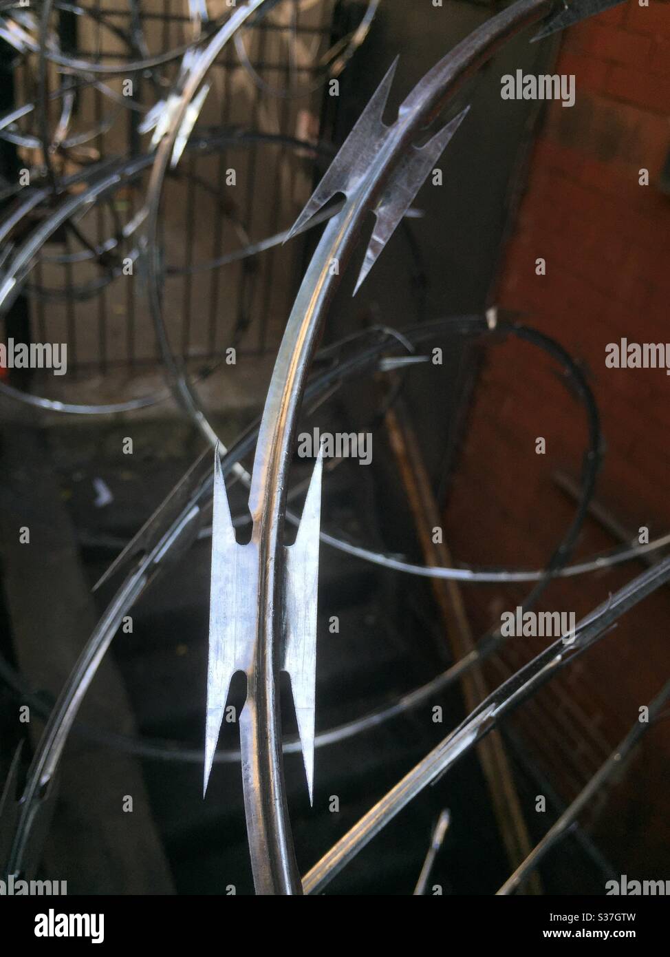 Close up of the blades on a coil of concertina wire placed in front of a midtown building as a result of earlier looting during the coronavirus pandemic, June 2020, NYC, USA Stock Photo