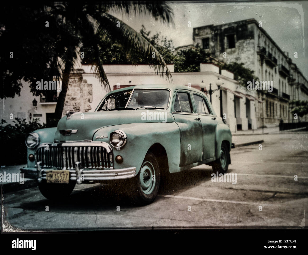 Green DeSoto custom 4 doors sedan on the streets of La Habana Vieja, Cuba Stock Photo