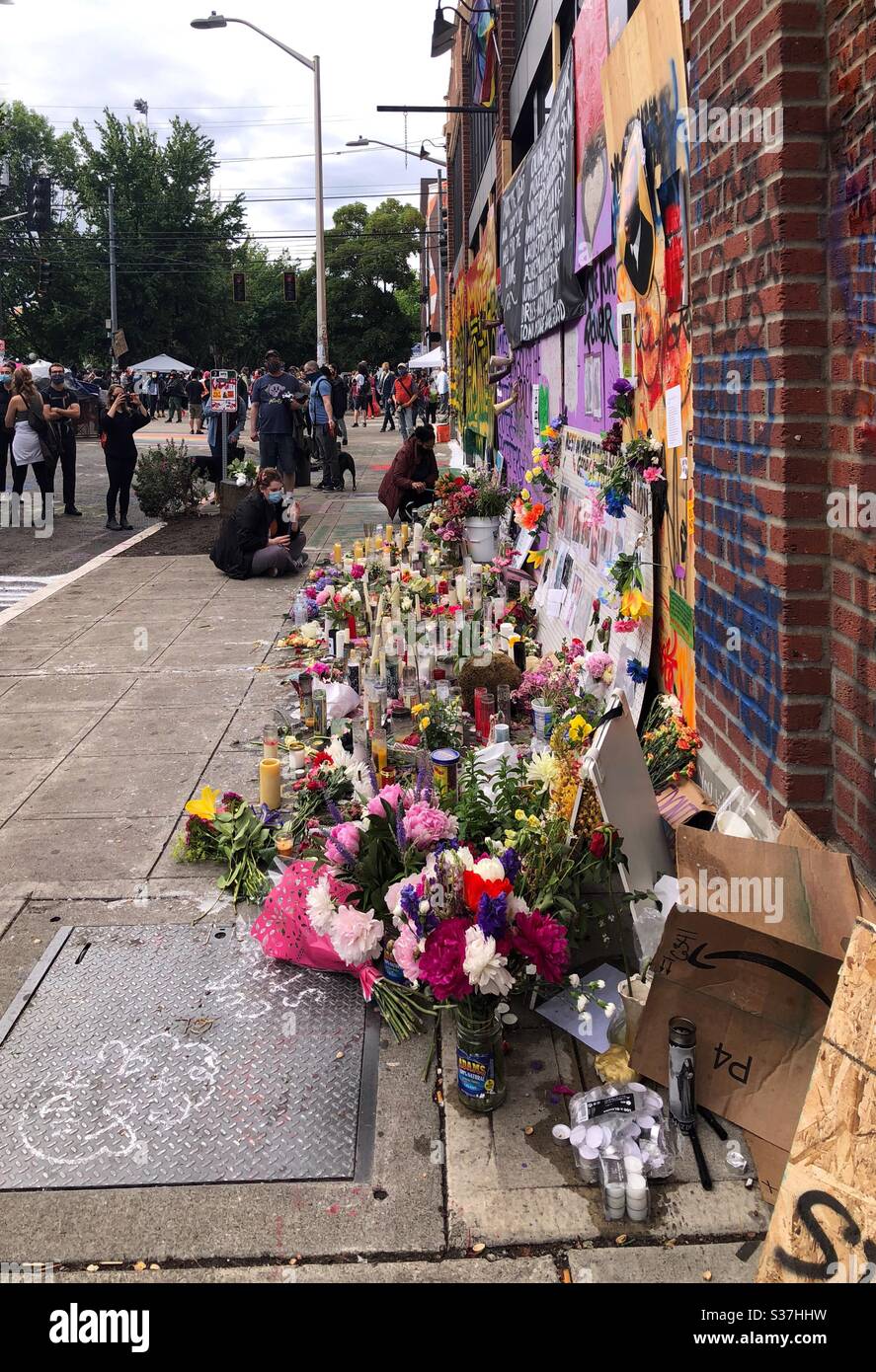 Flowers and candles at makeshift George Floyd memorial wall in CHOP CHAZ autonomous zone on Capitol Hill in Seattle, june 2020 Stock Photo