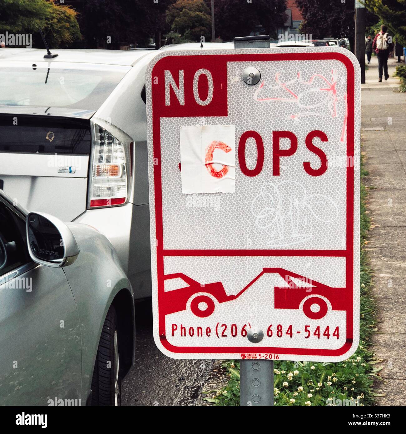 Altered NO STOPS sign on a street in Seattle reads NO COPS after protests on Capitol Hill Stock Photo