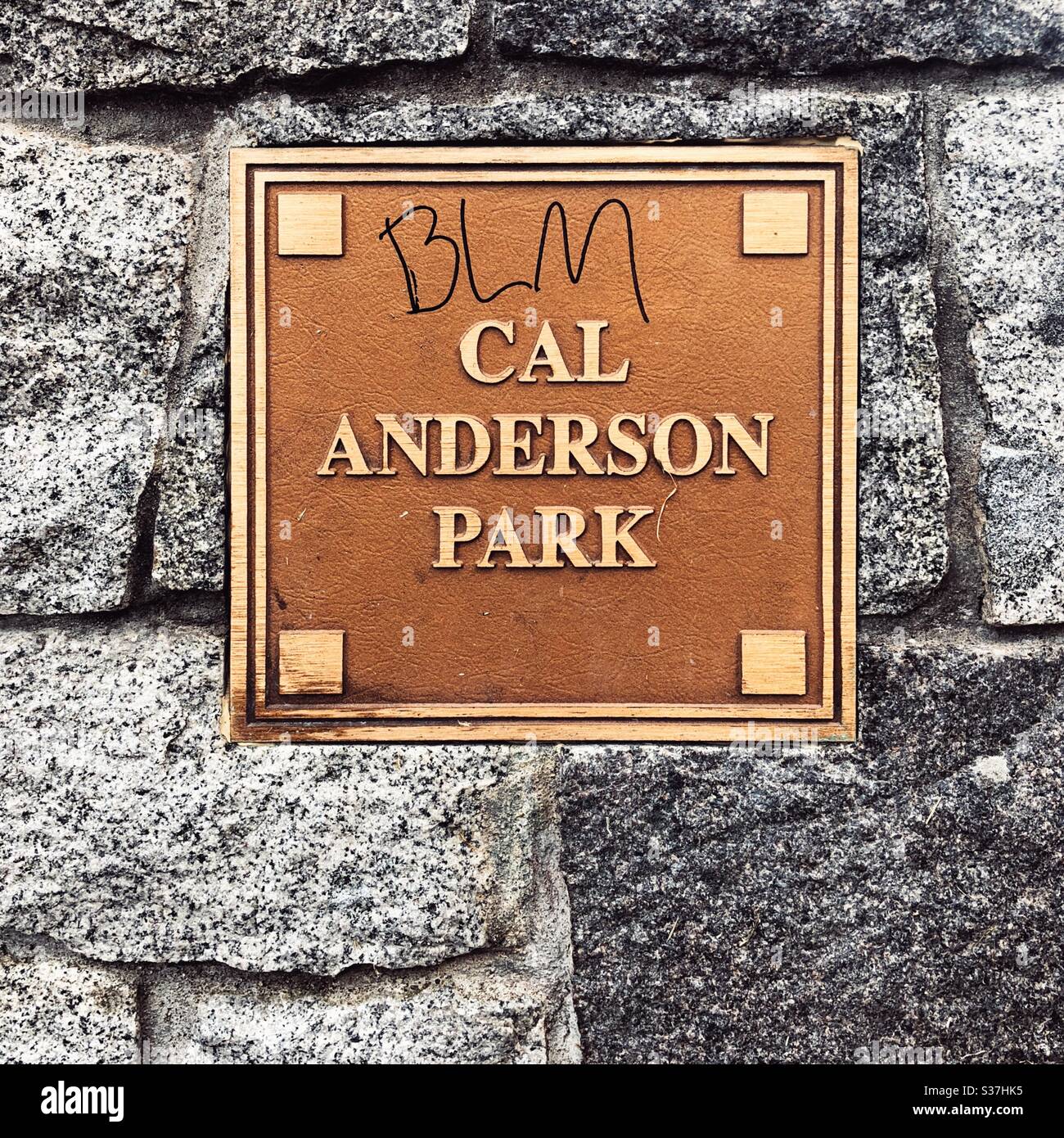 BLM written on a bronze plaque at Cal Andreson Park in Seattle near CHOP CHAZ autonomous zone Stock Photo