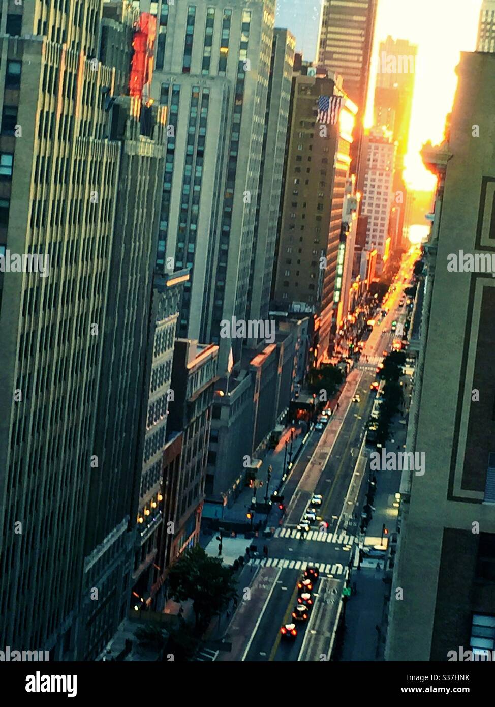 Manhattanhenge casts a golden glow  of the setting sun down W. 34th St. each June, NYC, USA - Smartphone Captured Stock Image