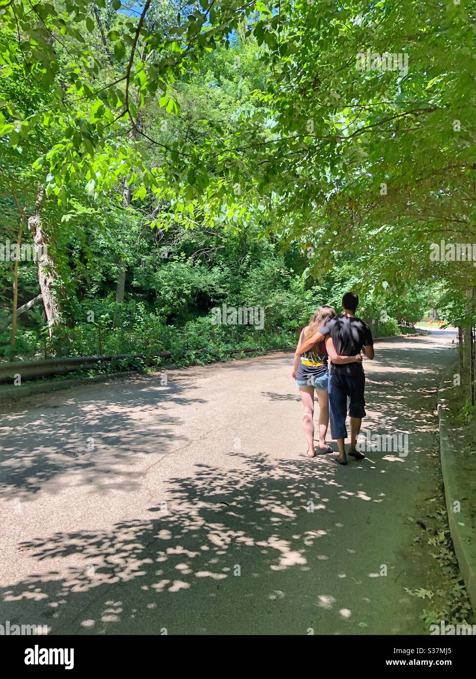 A young couple walking arm in arm Stock Photo Alamy