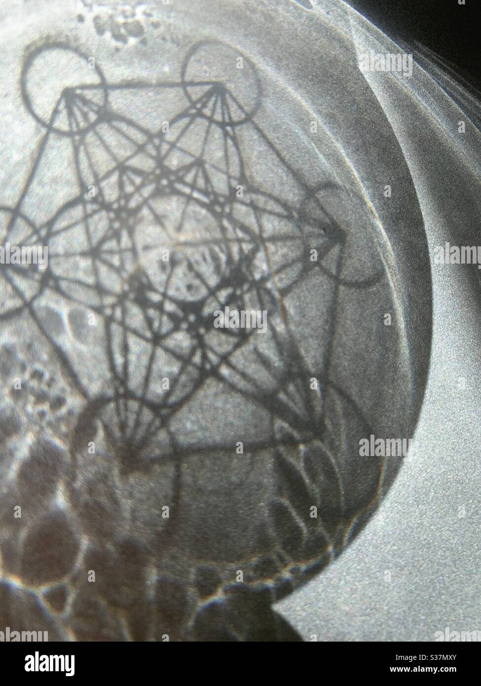 Metatrons cube reflected in circular silhouette - Smartphone Captured Stock Image