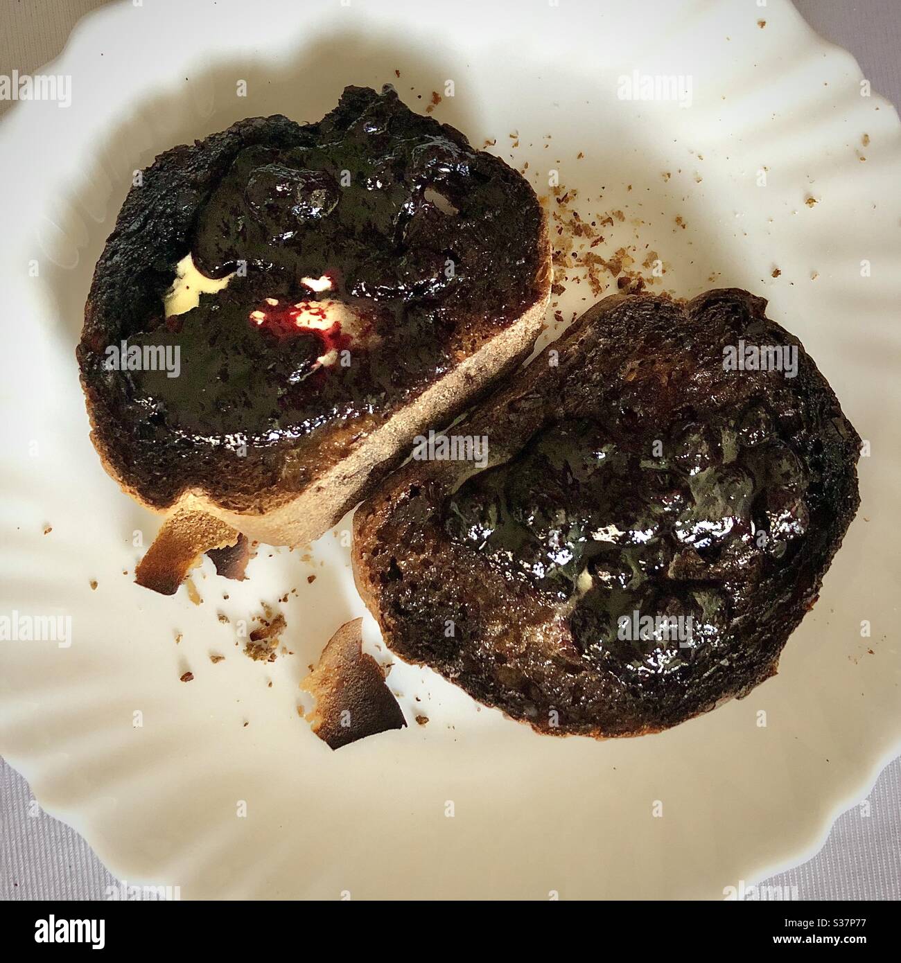 Two slices of burnt toast with blackberry jam. Stock Photo