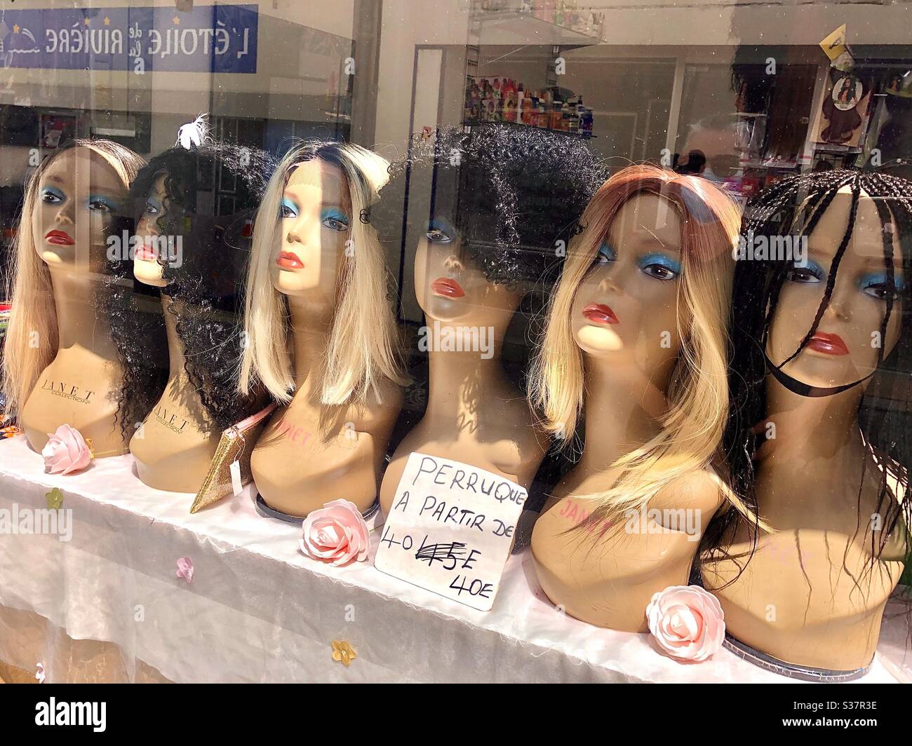 Window display of women’s wigs - France. Stock Photo