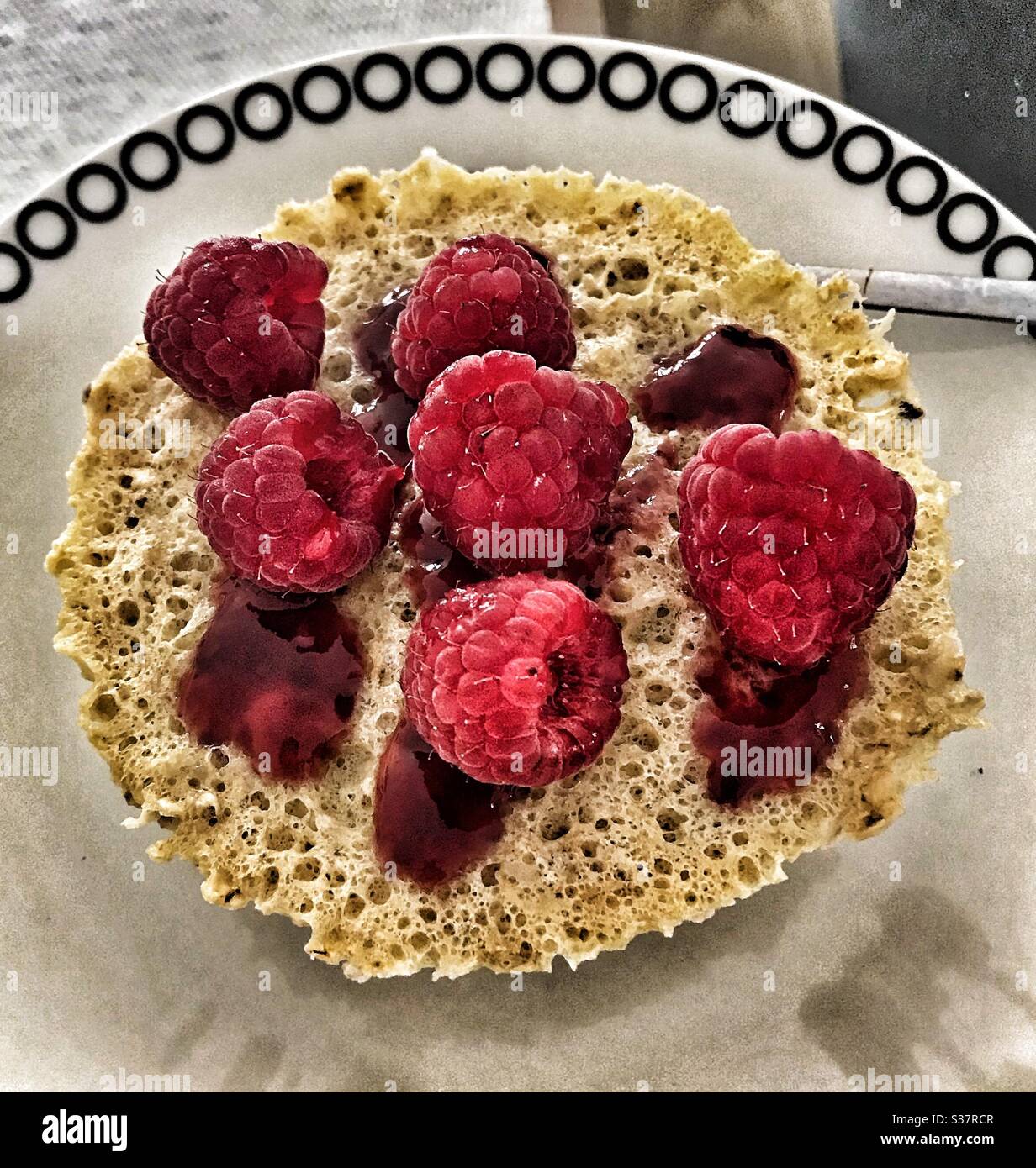 Banana Mug Cake with Fresh Raspberries and Raspberry Coulis - Smartphone Captured Stock Image