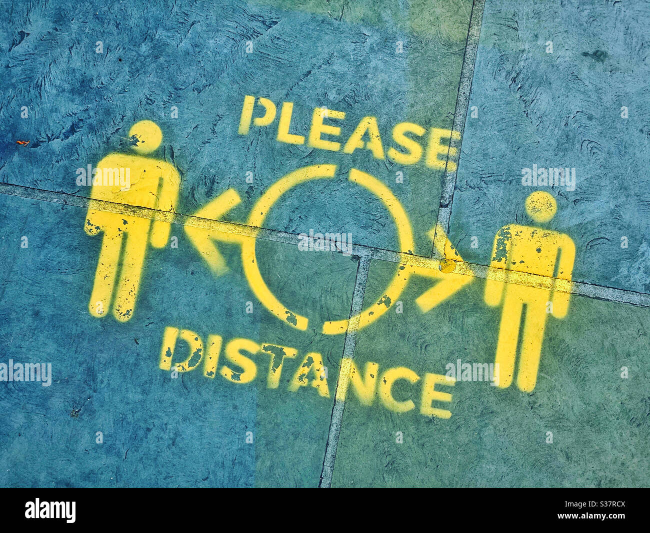 PLEASE DISTANCE - a sign spray painted on the pavement outside a shop in England. The Covid-19 outbreak meant people needed to stay apart to halt the spread of Coronavirus. Photo ©️ COLIN HOSKINS. - Smartphone Captured Stock Image