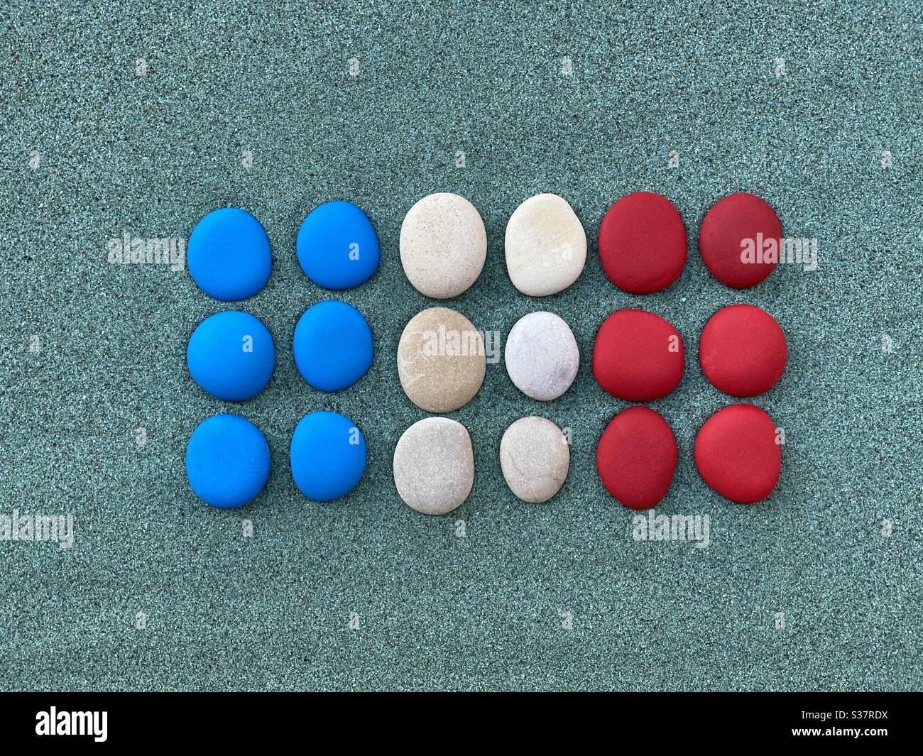 France flag composed with colored pebbles over green sand - Smartphone Captured Stock Image