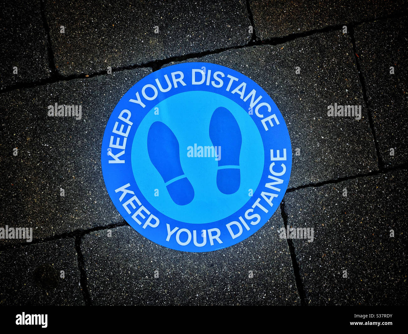 KEEP YOUR DISTANCE. Keep 2 metres distance to reduce the spread of Covid-19. An image on the pavement/walkway during Lockdown. Photo ©️ COLIN HOSKINS. - Smartphone Captured Stock Image