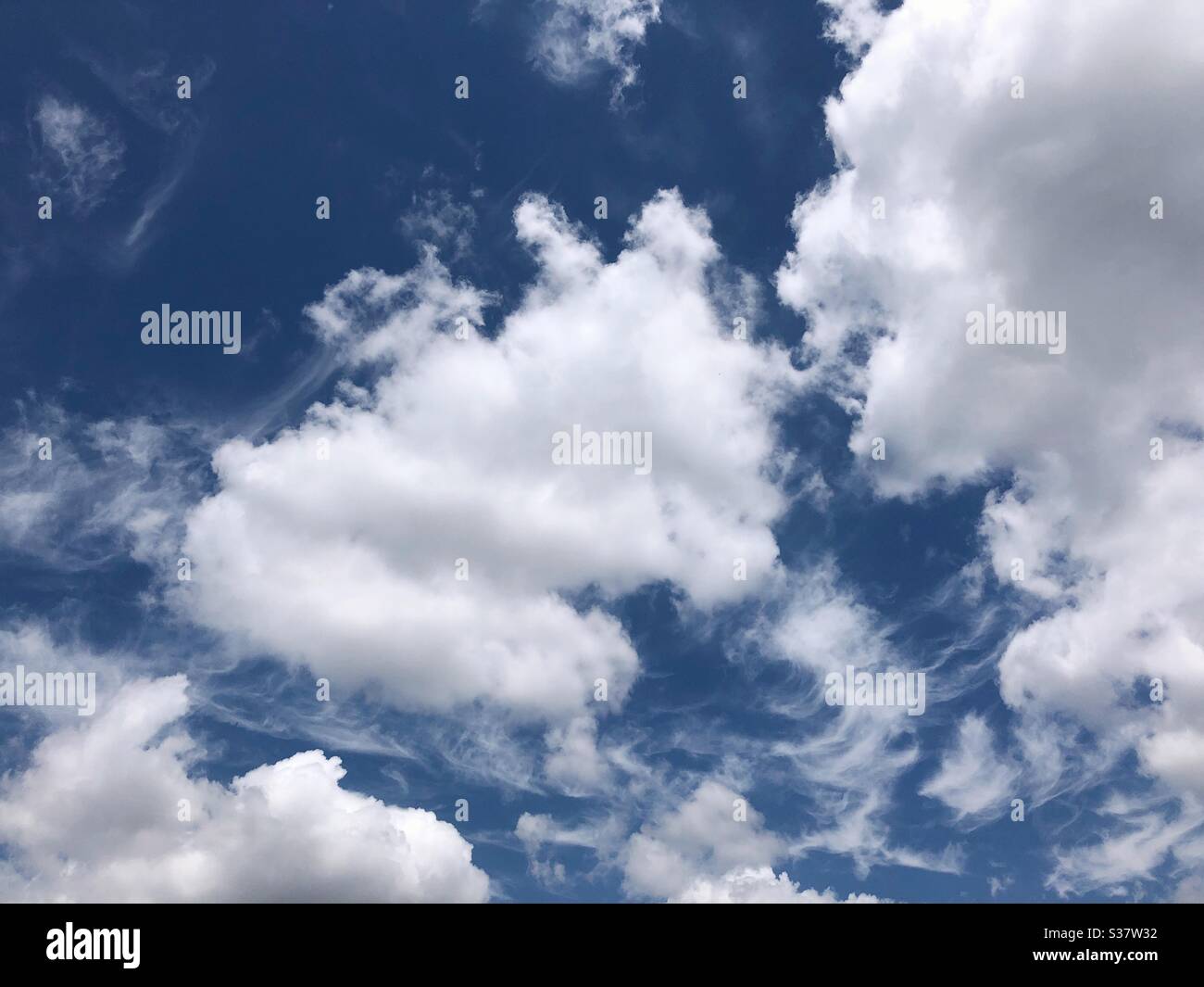 Fluffy clouds in the blue sky. Stock Photo