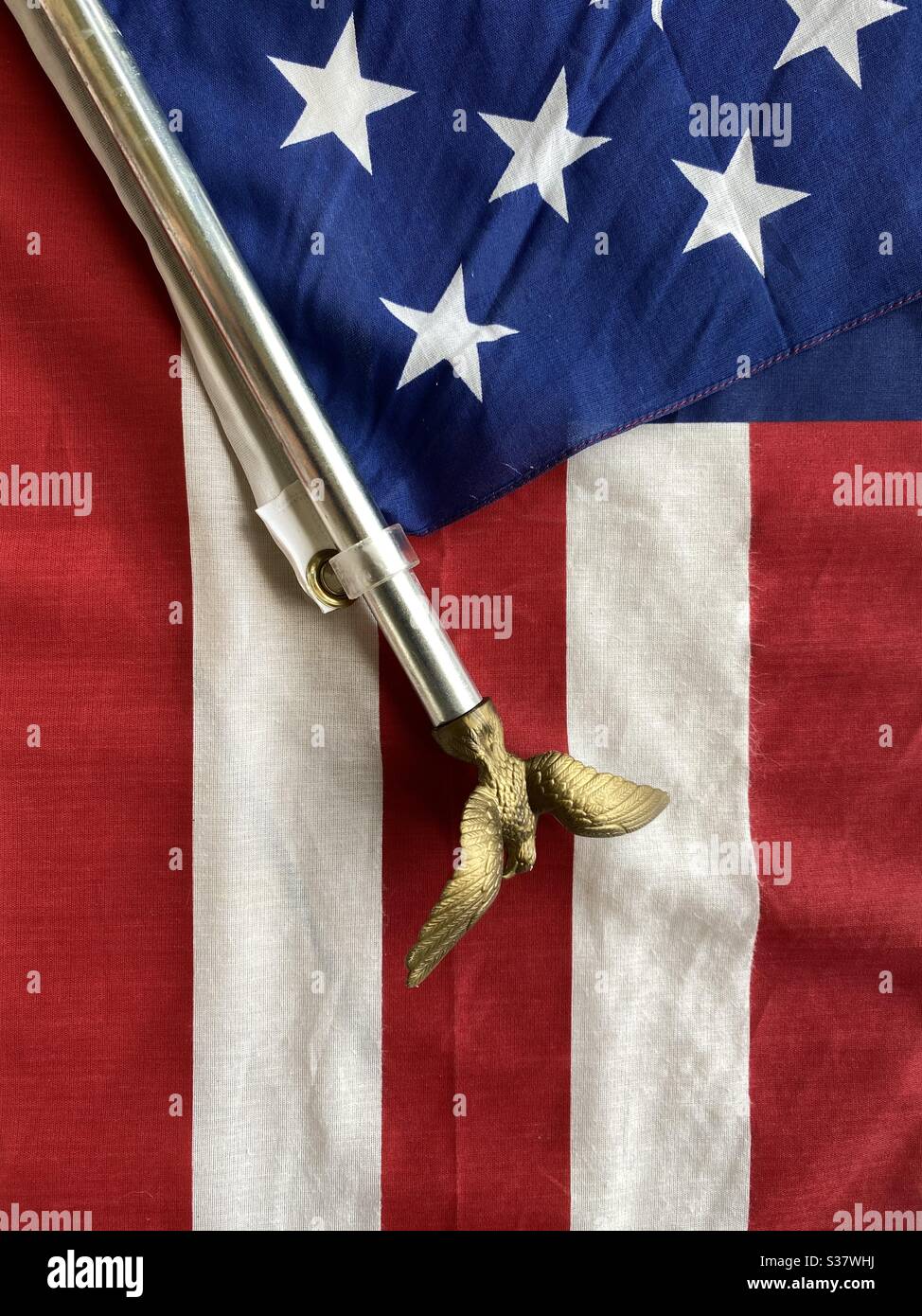 American flag with a golden eagle on a pole - Smartphone Captured Stock Image