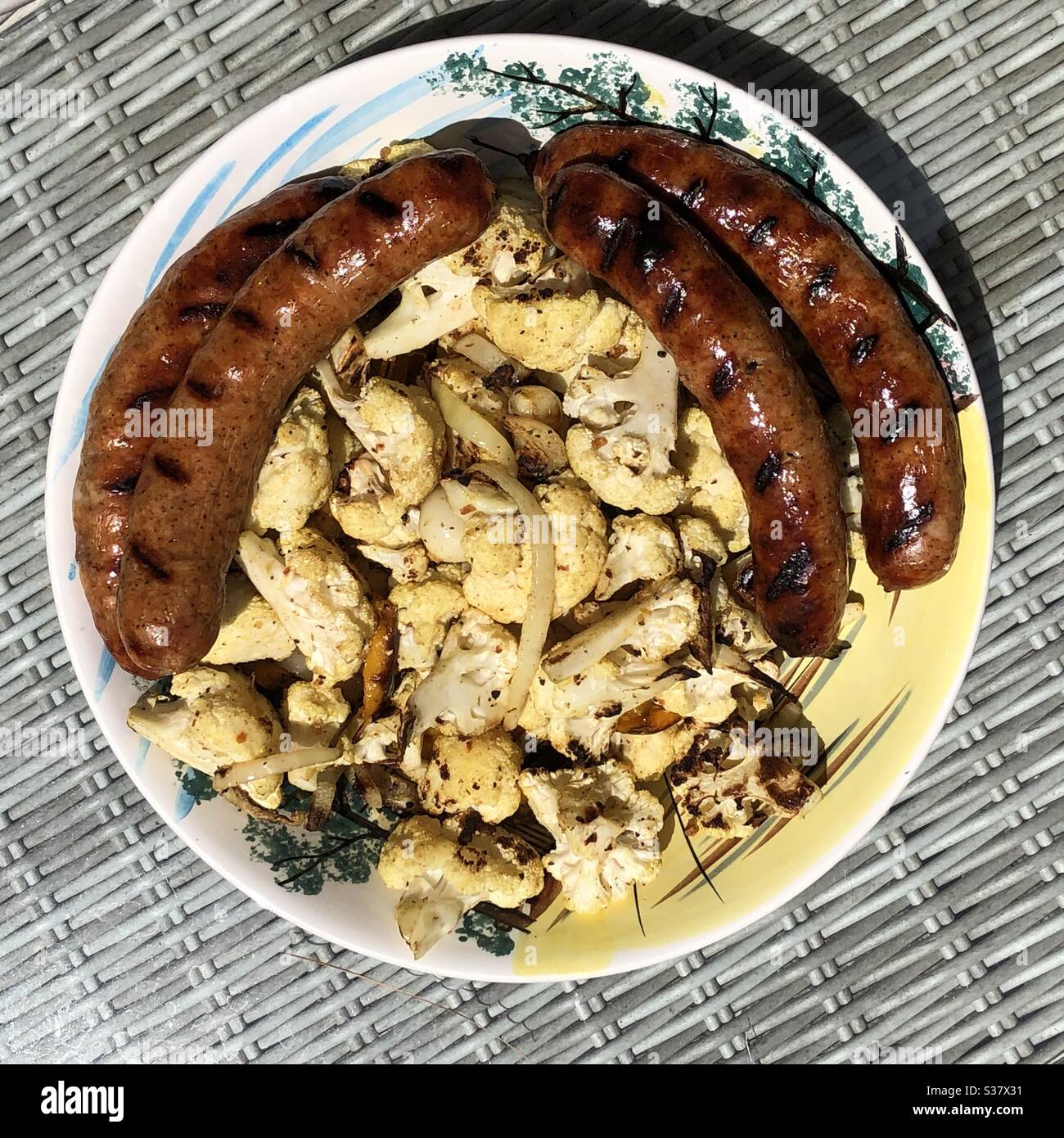 Grilled sausages and cauliflower on the plate. - Smartphone Captured Stock Image