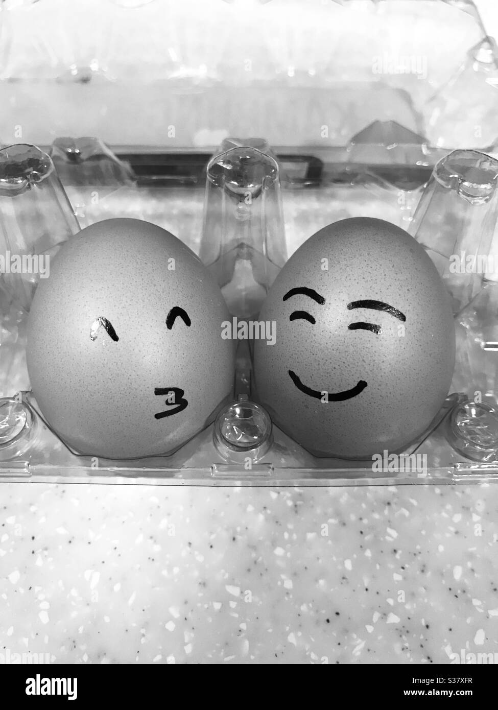 Mixed feeling Eggs in egg holder , Easter eggs, Happy Eggs Stock Photo