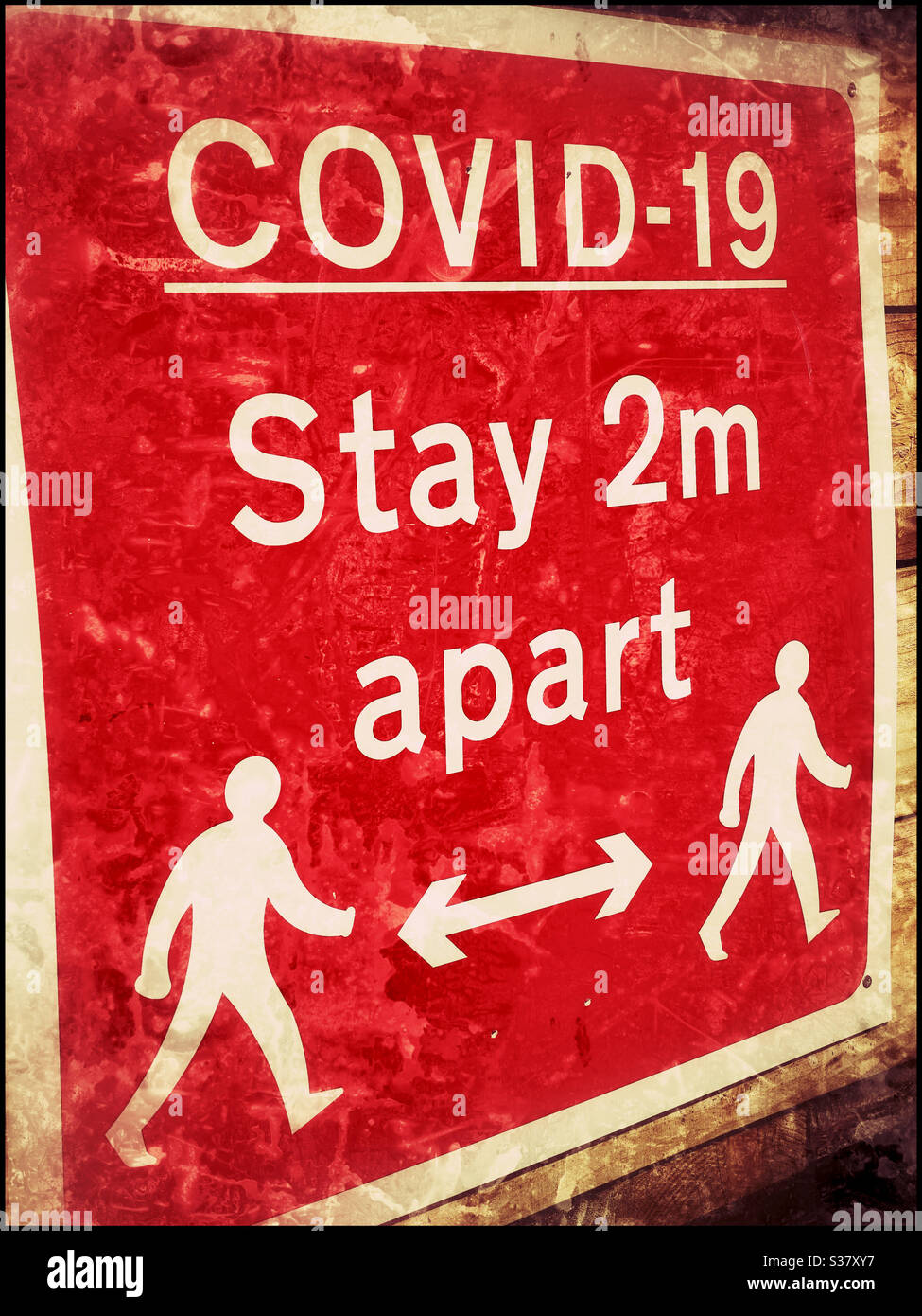 An atmospheric effect image from June 2020 - a sign in England advising people to maintain a 2 metre separation for health and safety reasons during the Covid-19 Pandemic. Photo ©️ COLIN HOSKINS. - Smartphone Captured Stock Image