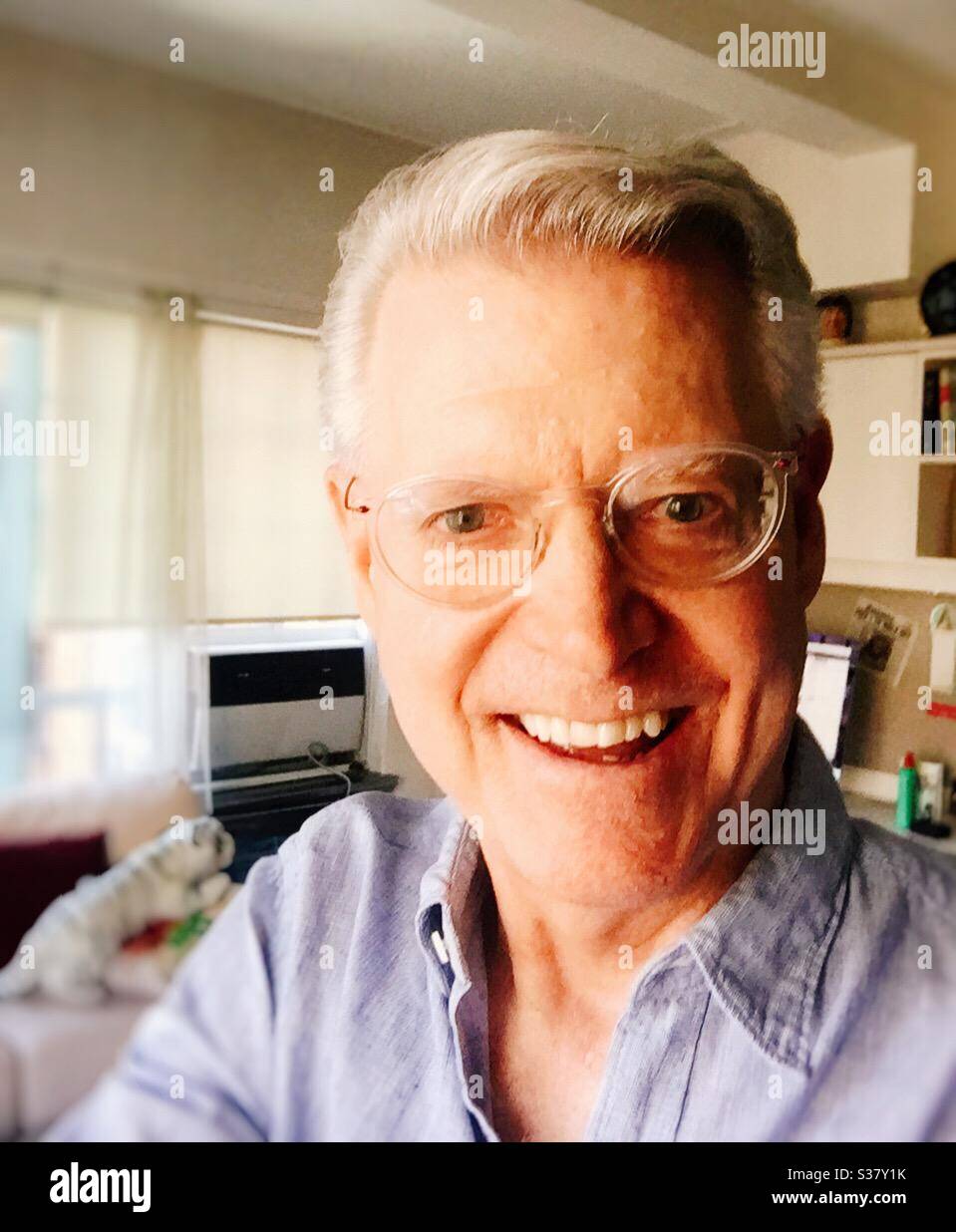 Ruggedly handsome clean-cut Caucasian senior taking a selfie, USA - Smartphone Captured Stock Image