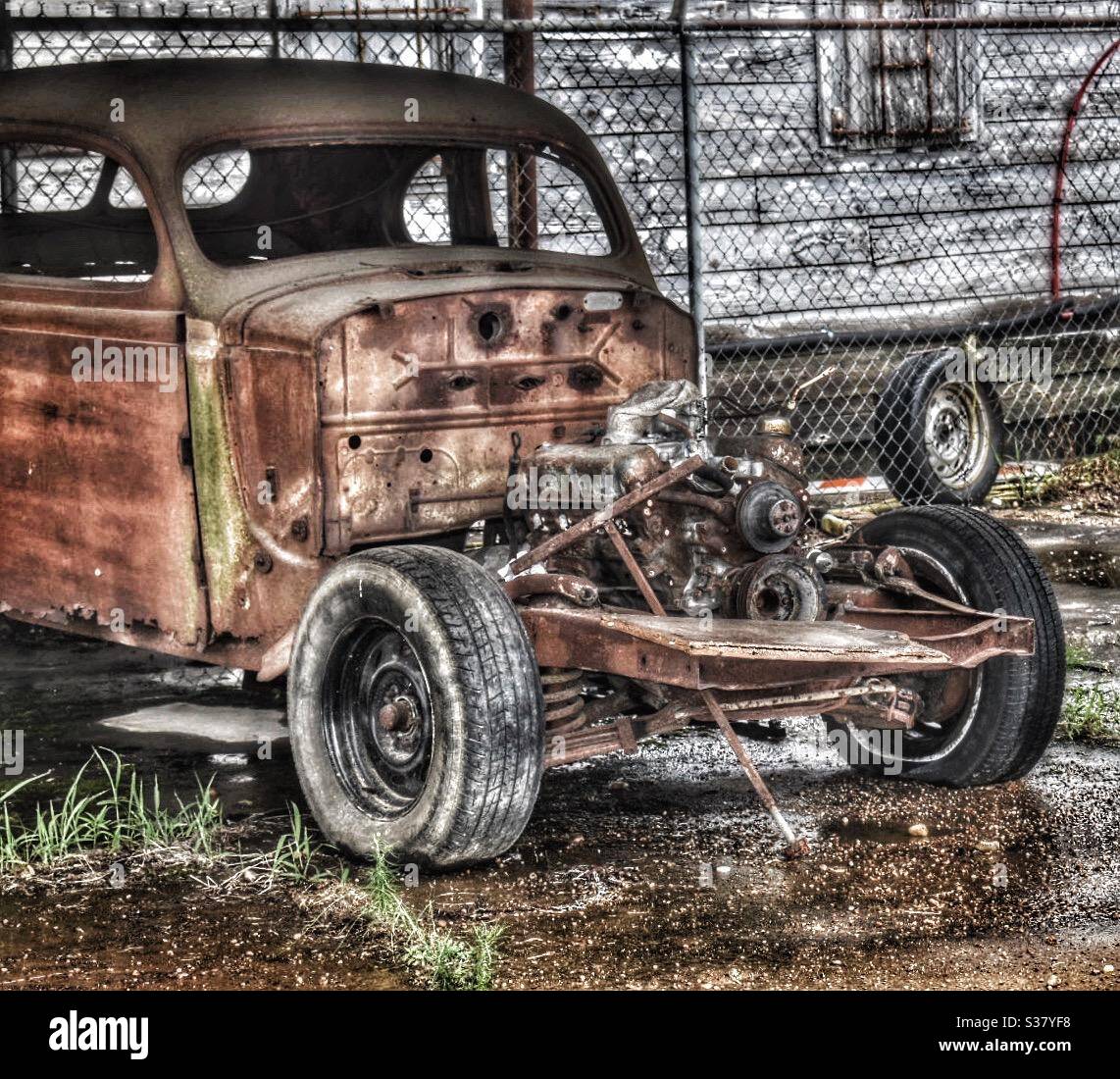 Old rusty patina abandoned hot rod without the hood sitting in the rain  Stock Photo - Alamy
