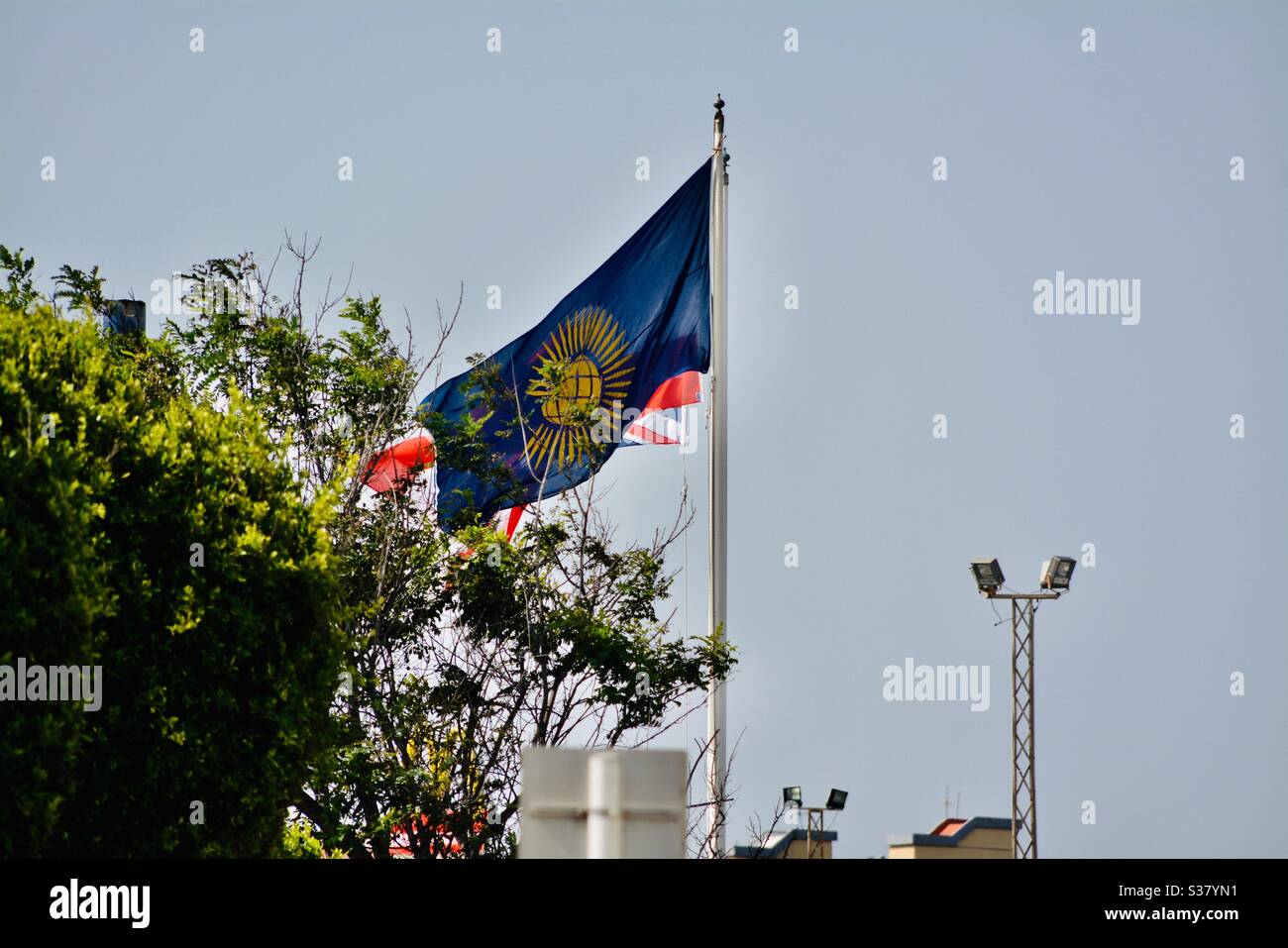 Commonwealth flag flying at the Gibraltar land border with Spain alongside the Gibraltar and British Flag, replacing the EU flag Stock Photo