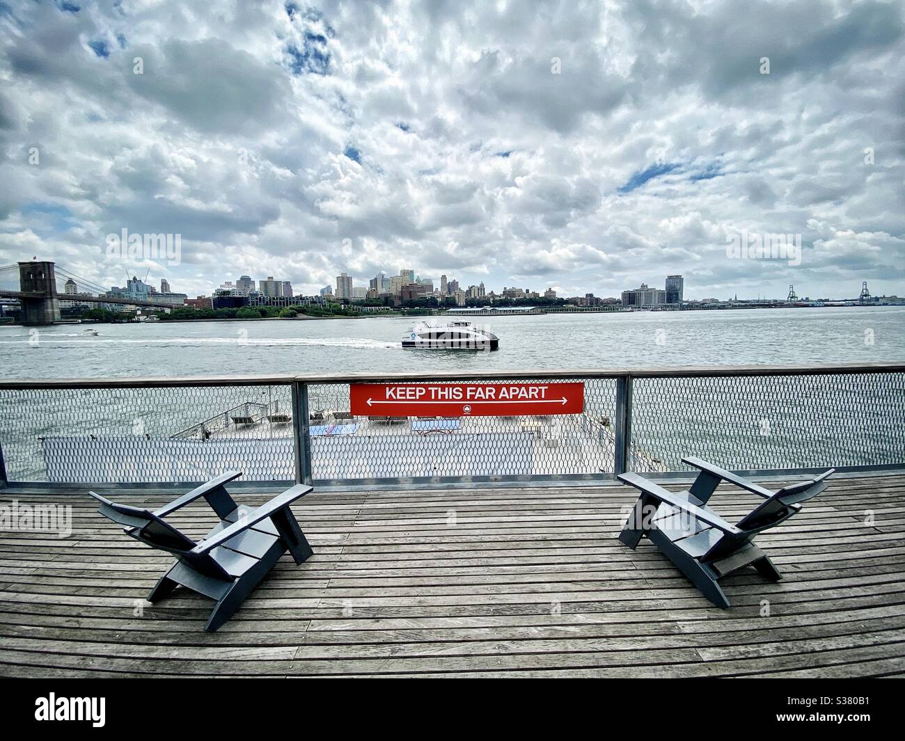 6 feet apart sign at South Street Seaport over looking the East River and Brooklyn, New York City. - Smartphone Captured Stock Image