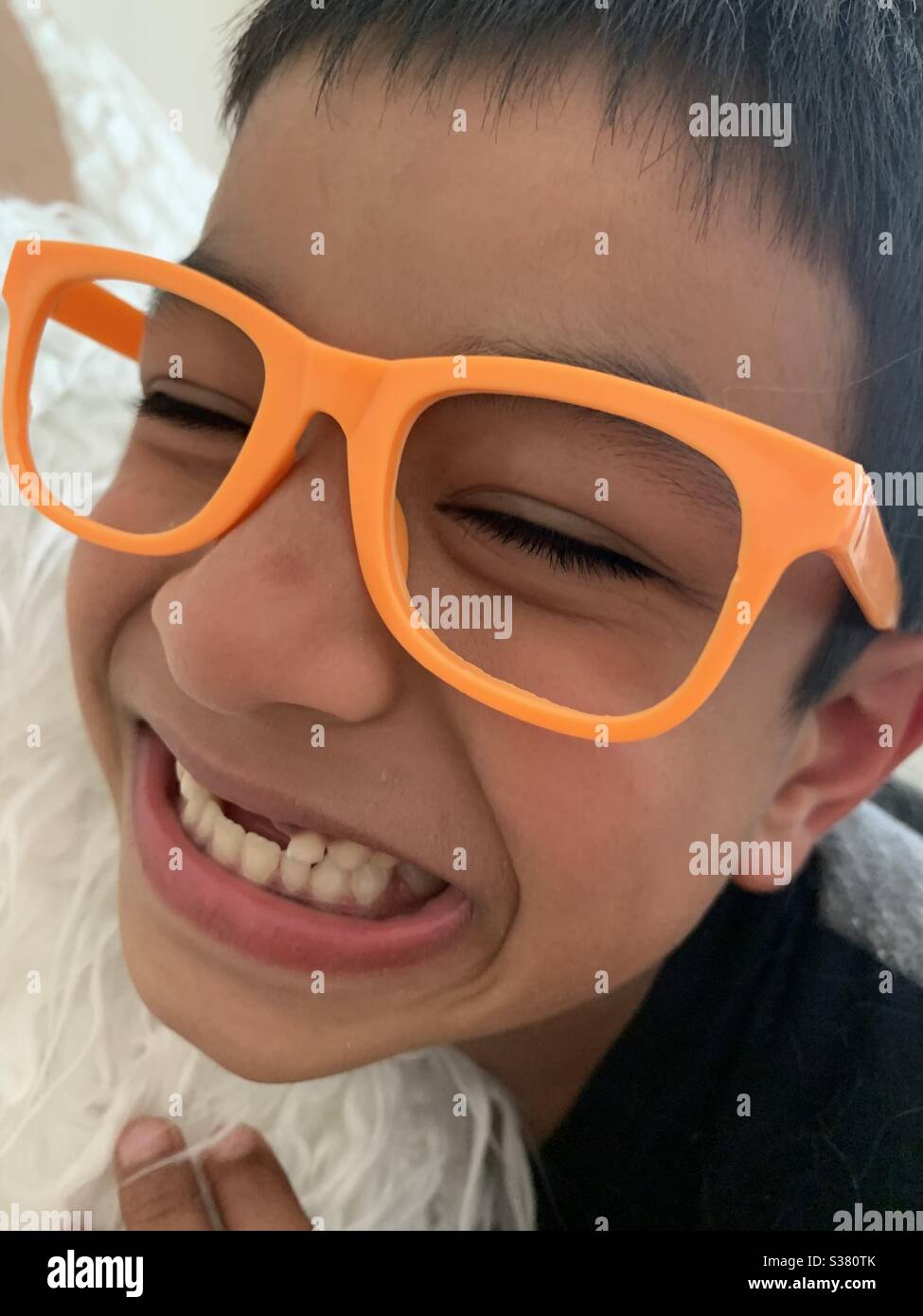 Smiling toothless child with play glasses Stock Photo Alamy