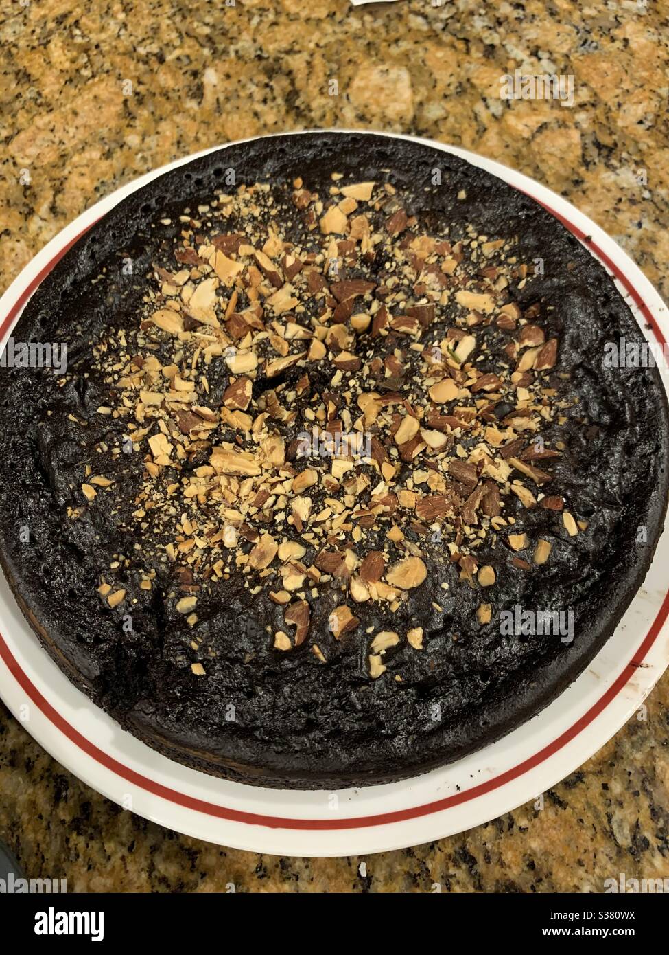 Chocolate cake with chopped nuts garnish Stock Photo Alamy