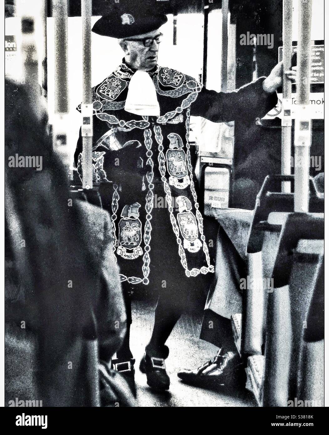 An elderly man in a town criers uniform on a London bus in Chelsea. - Smartphone Captured Stock Image
