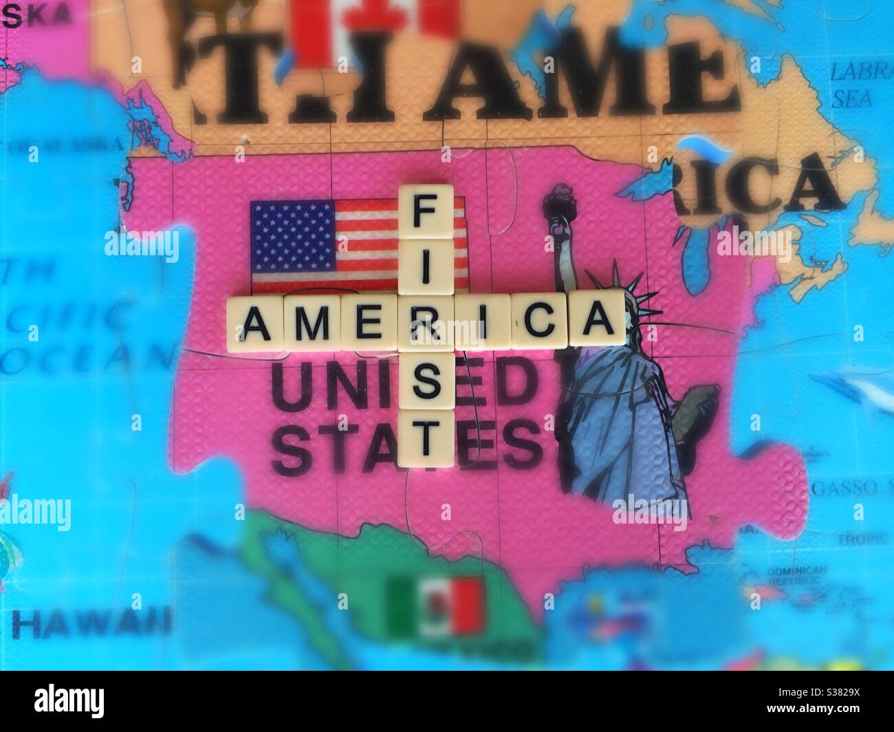 America First, or America alone, in words, icons, and 3D puzzle map. USA fading. MAGA. In Decline. Lost hegemony. Adrift Stock Photo