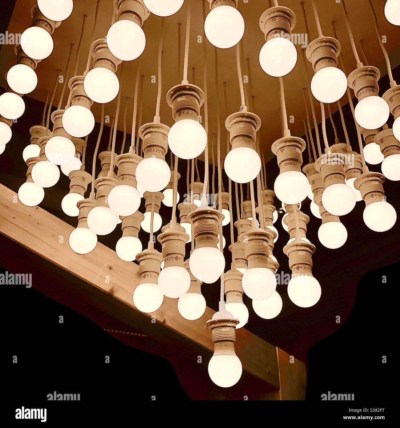 Overhead display of bare bulbs in IKEA store - France. Stock Photo