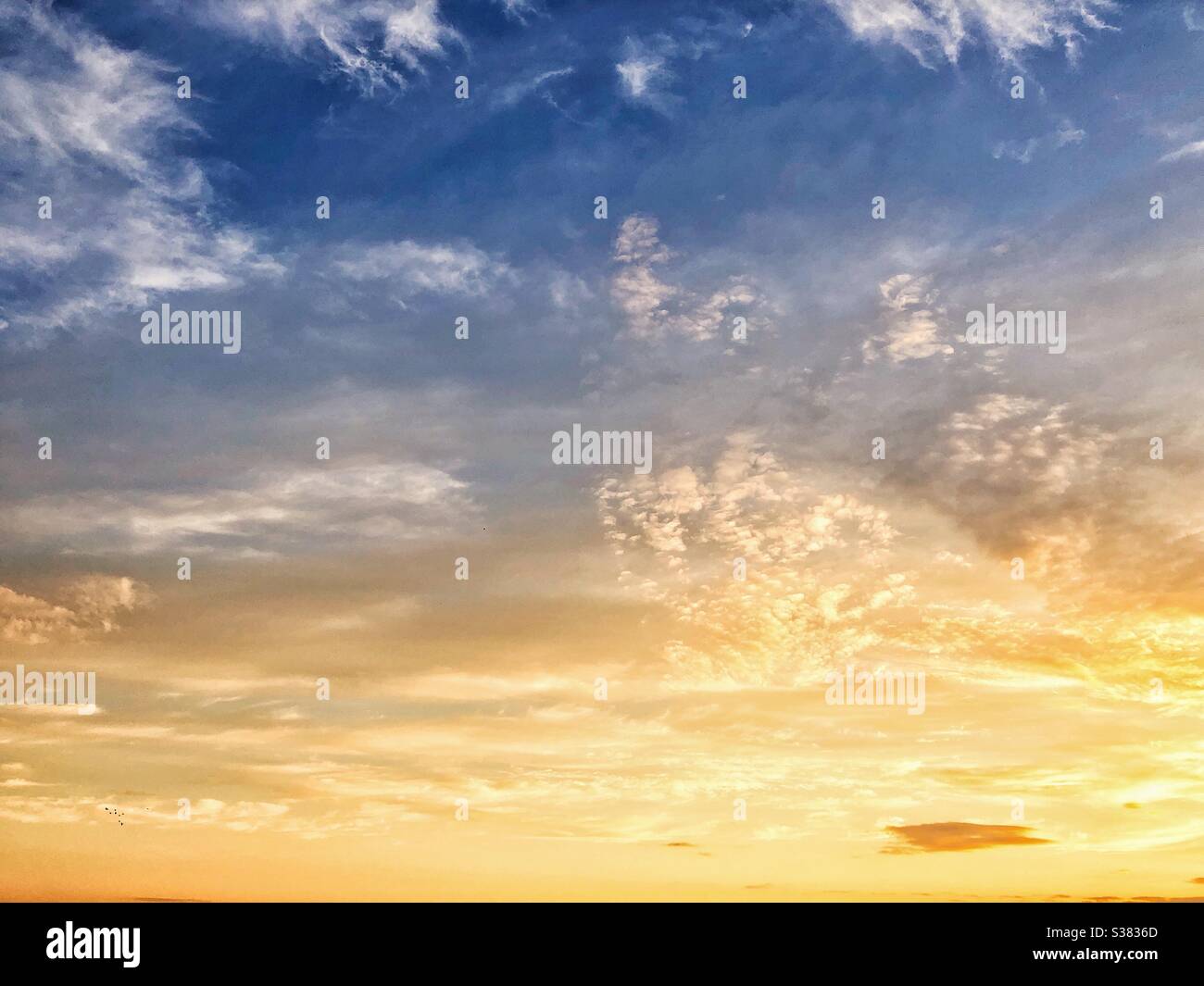 A sunset illuminates the sky. Stock Photo